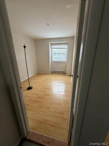 Corridor featuring light wood finished floors Corridor featuring light wood finished floors