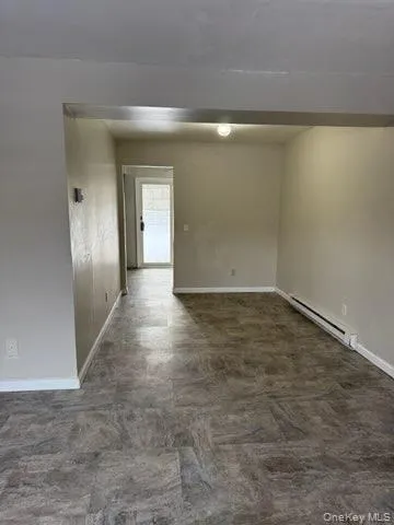 Empty room with a baseboard heating unit and baseboards Empty room with a baseboard heating unit and baseboards