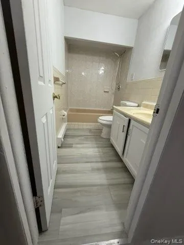 Full bathroom featuring vanity and shower combination Full bathroom featuring vanity and shower combination