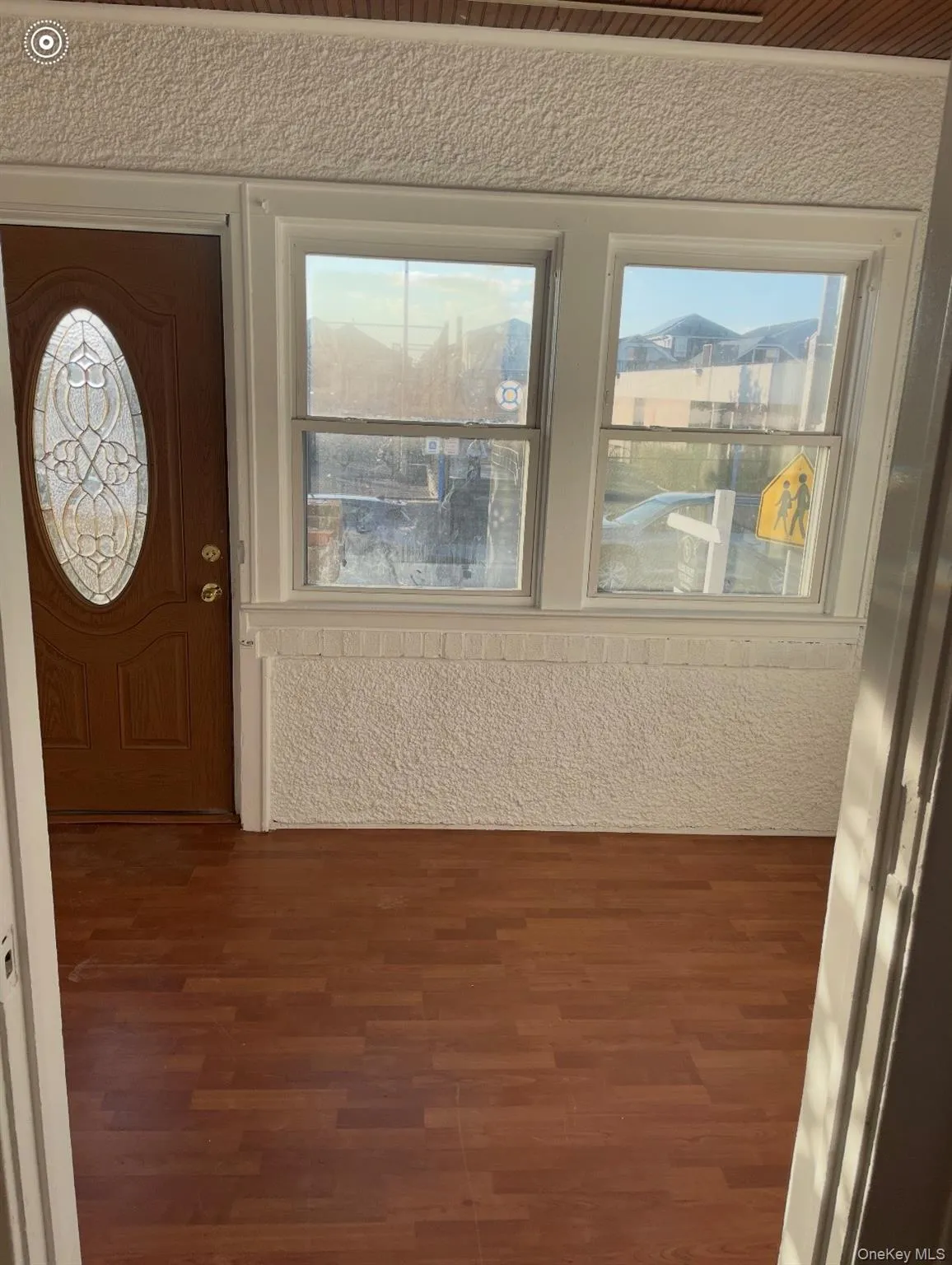 Entryway featuring dark wood-style flooring and healthy amount of natural light Entryway featuring dark wood-style flooring and healthy amount of natural light