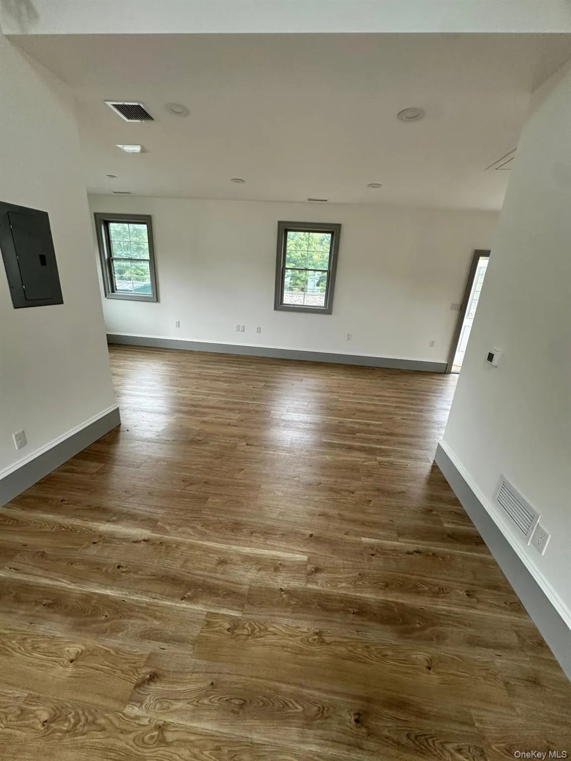 Empty room with electric panel and light wood finished floors Empty room with electric panel and light wood finished floors