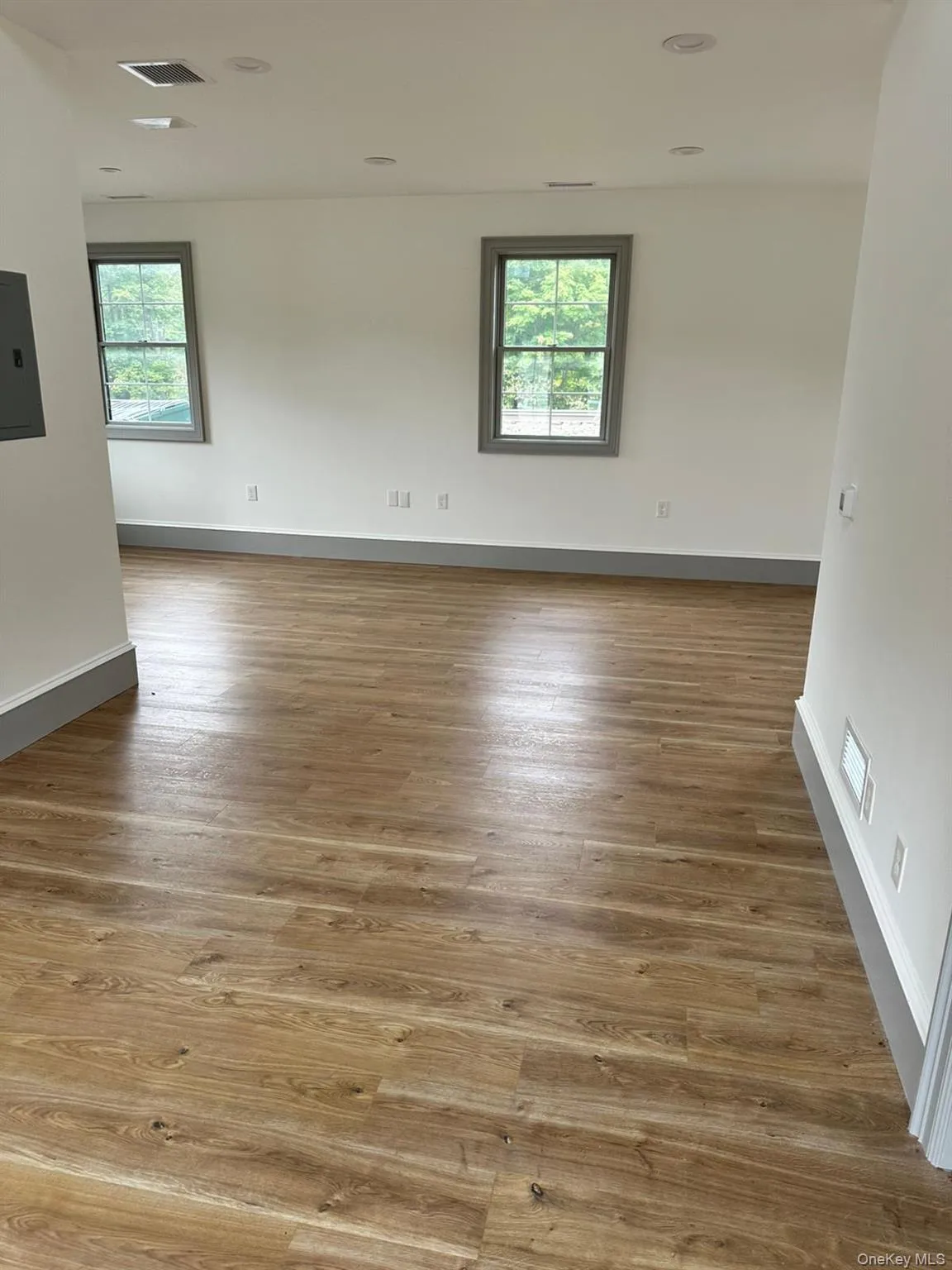 Unfurnished room with light wood-style flooring and electric panel Unfurnished room with light wood-style flooring and electric panel