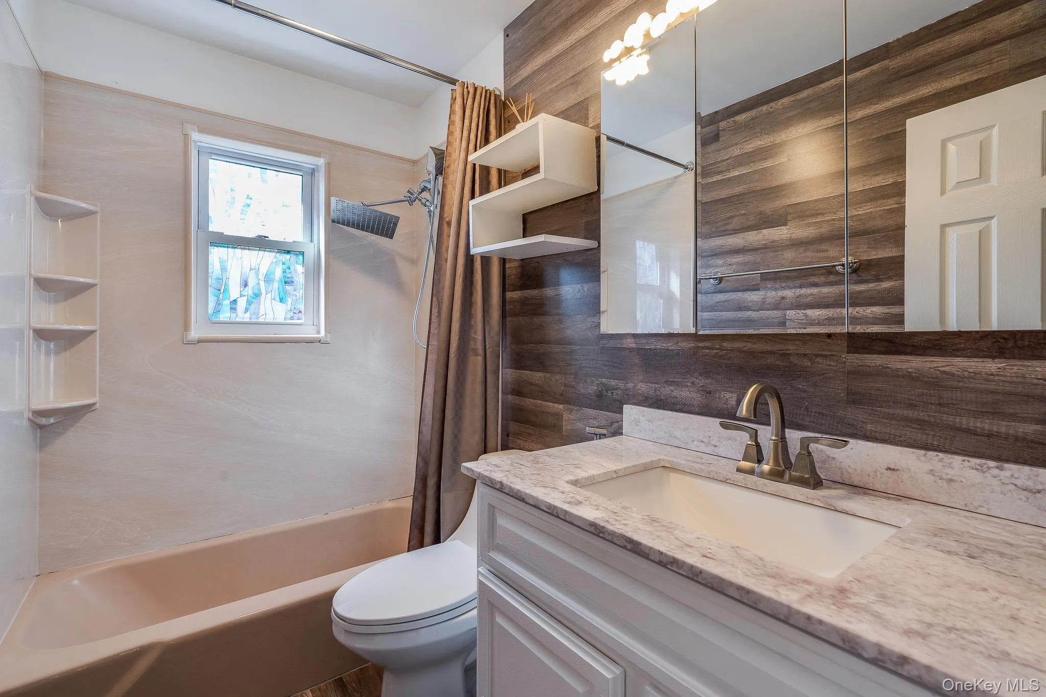 Full bathroom featuring shower / bathtub combination with curtain and vanity Full bathroom featuring shower / bathtub combination with curtain and vanity