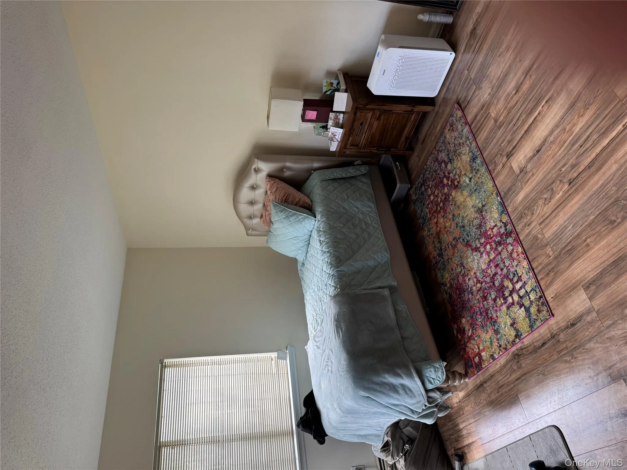 Bedroom with a textured ceiling and wood finished floors Bedroom with a textured ceiling and wood finished floors