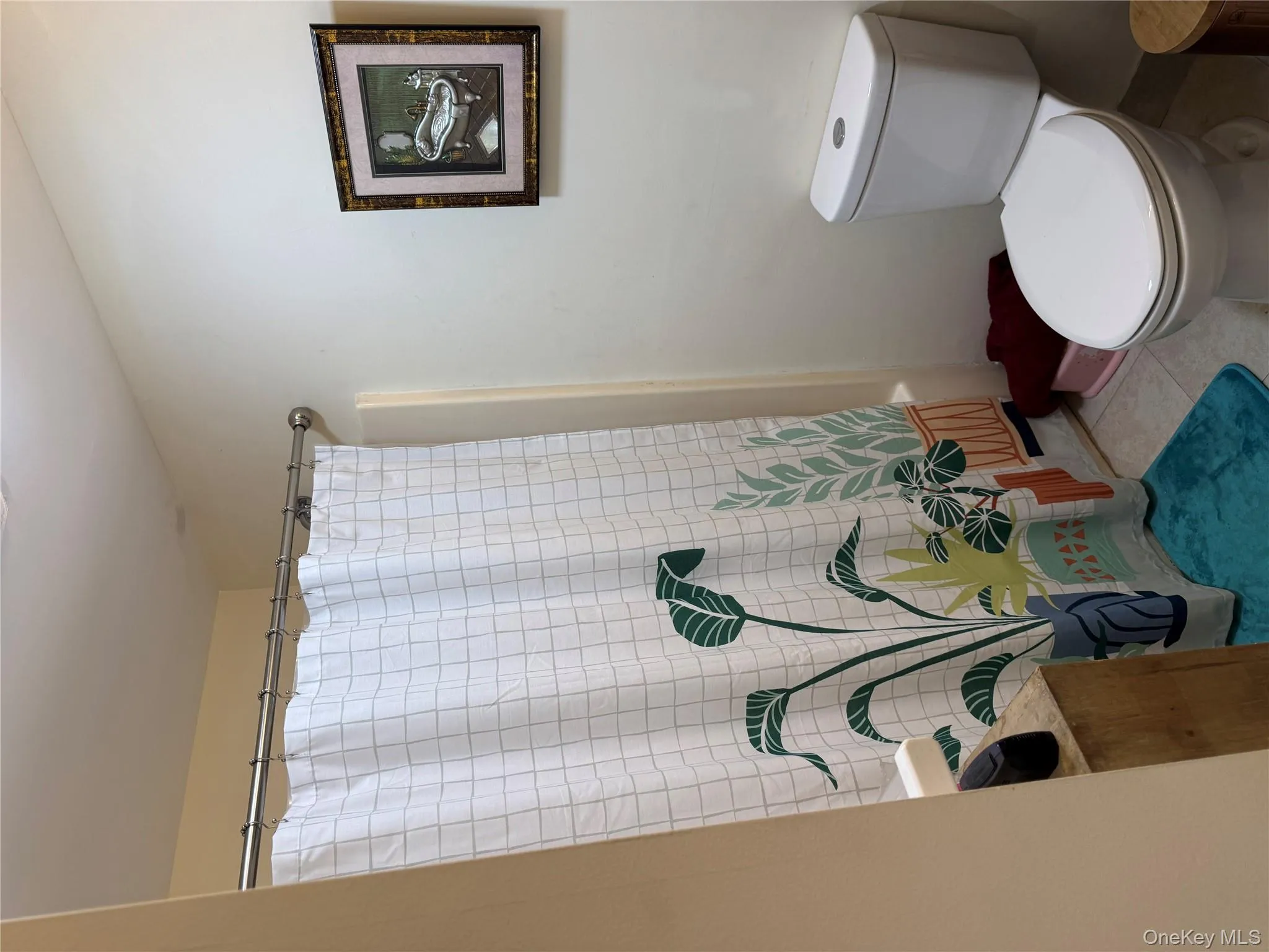 Bathroom with tile patterned floors and shower / bath combination with curtain Bathroom with tile patterned floors and shower / bath combination with curtain