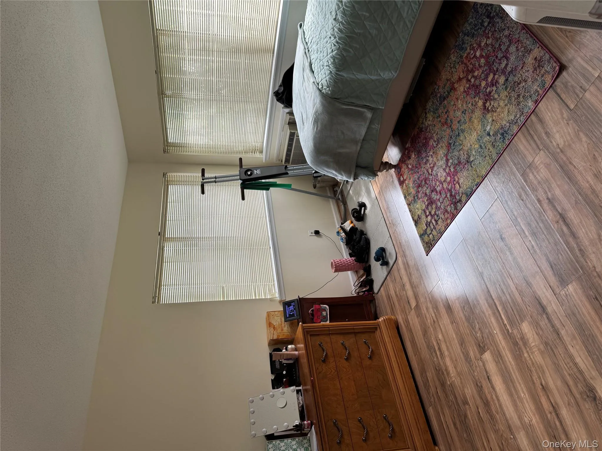 Bedroom with a textured ceiling and wood finished floors Bedroom with a textured ceiling and wood finished floors