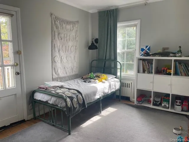 Bedroom with radiator heating unit Bedroom with radiator heating unit