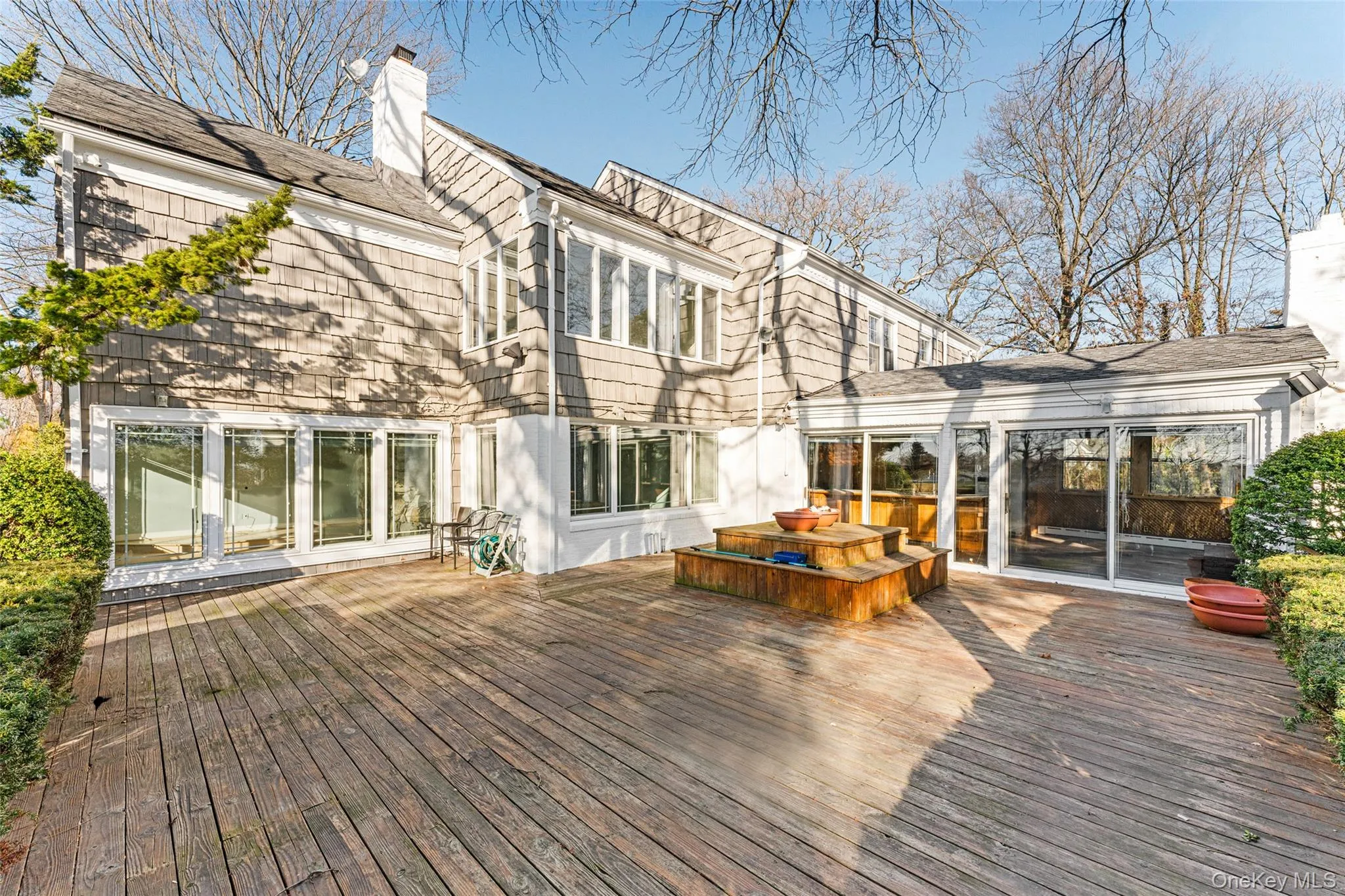 Wooden deck featuring a sunroom Wooden deck featuring a sunroom