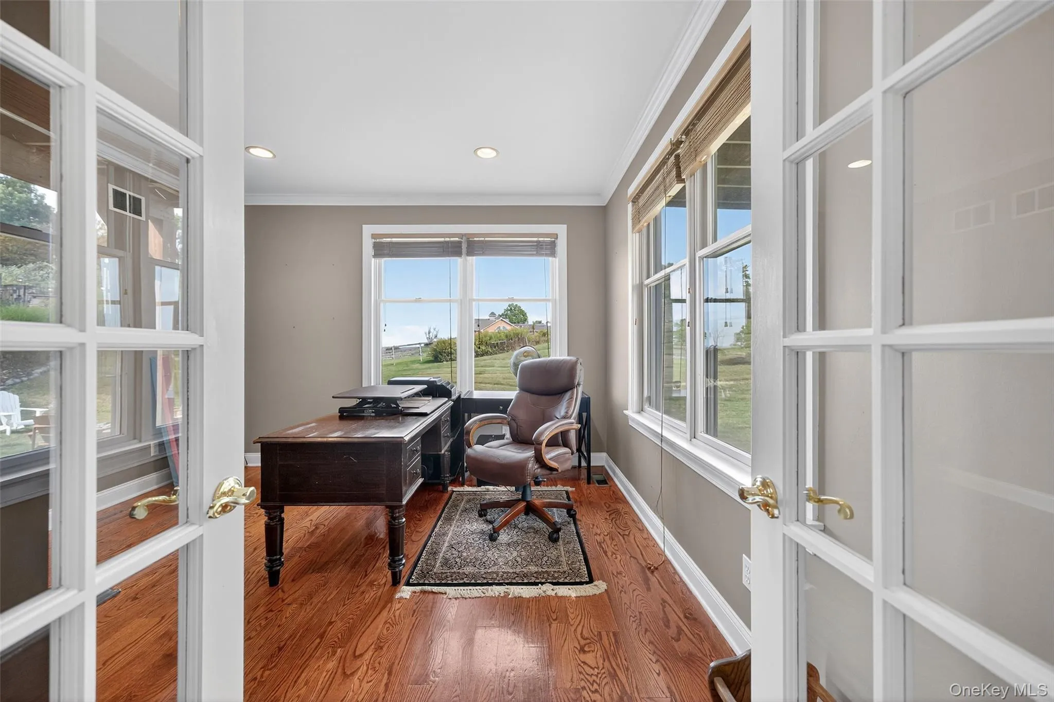 Home office featuring French doors, wood floors, and recessed lighting. Home office featuring French doors, wood floors, and recessed lighting.