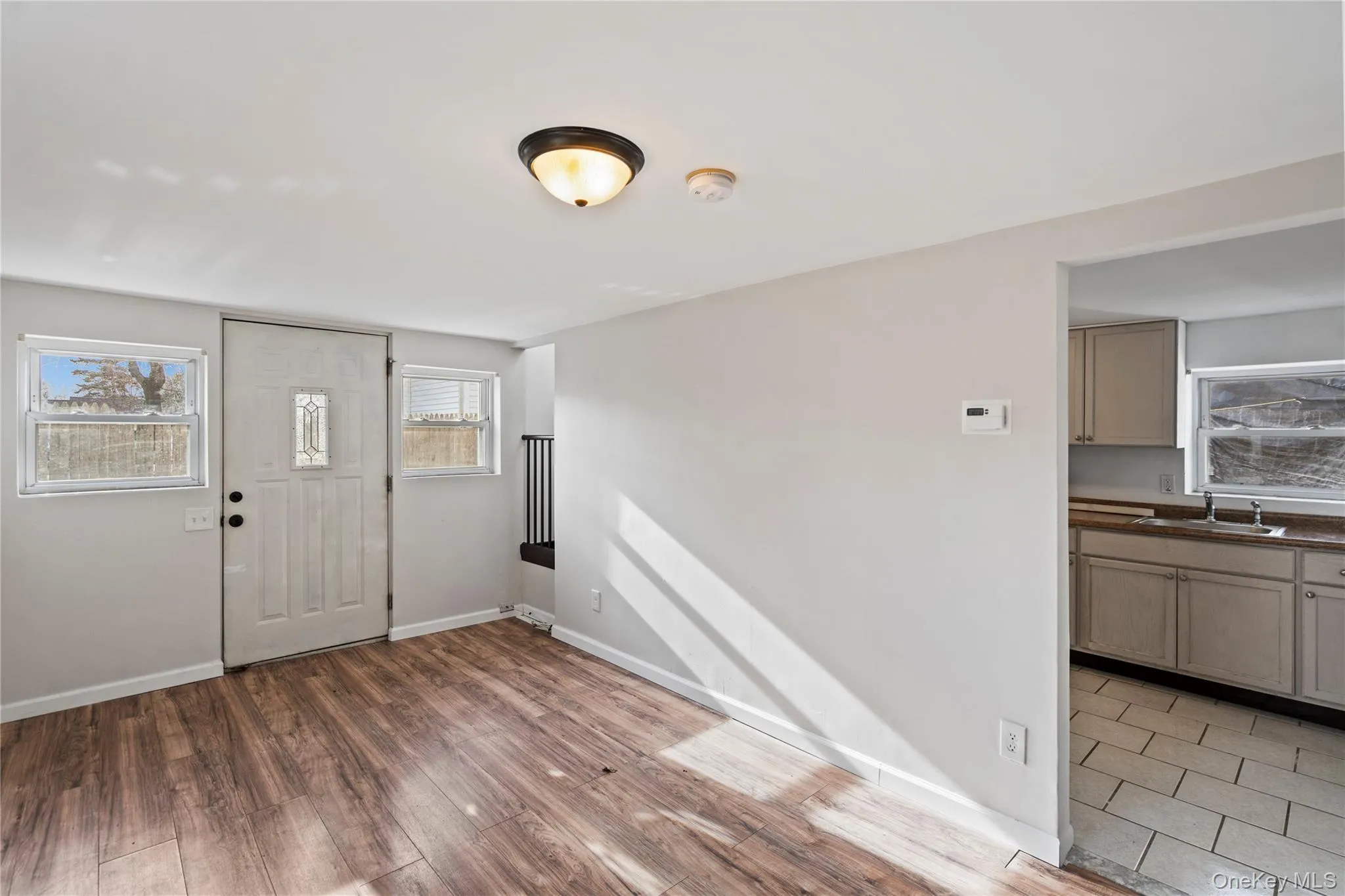Foyer with light wood-style floors and baseboards Foyer with light wood-style floors and baseboards