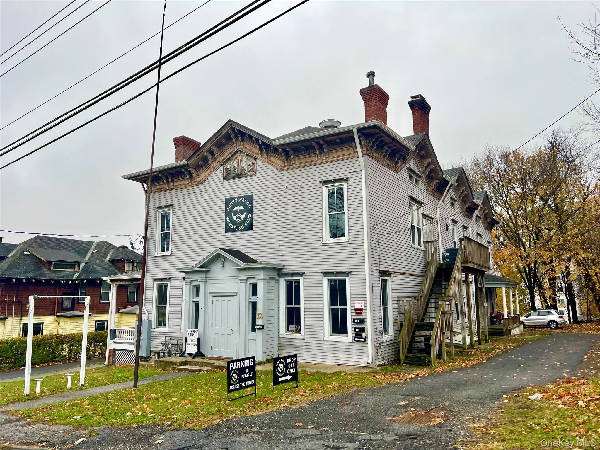 Italianate house featuring a chimney and stairs Italianate house featuring a chimney and stairs