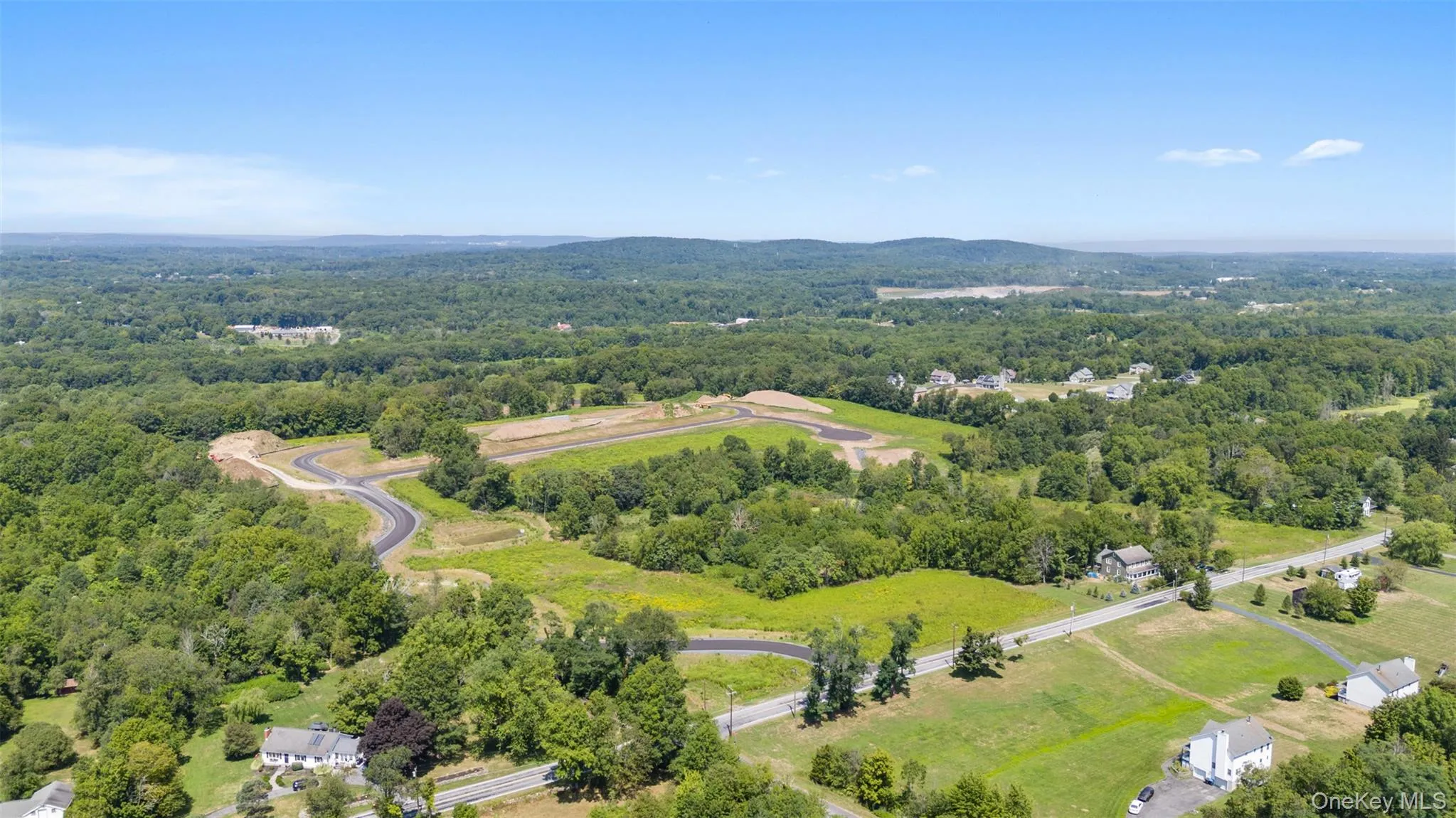 Aerial view of a heavily wooded area and mountains Aerial view of a heavily wooded area and mountains
