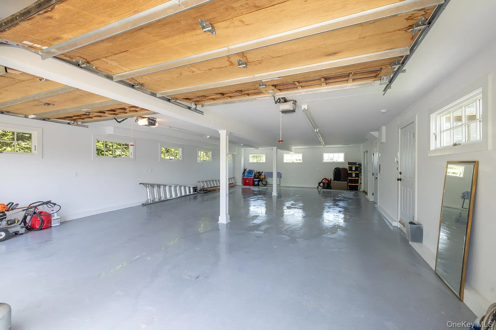 Garage with a garage door opener and baseboards Garage with a garage door opener and baseboards