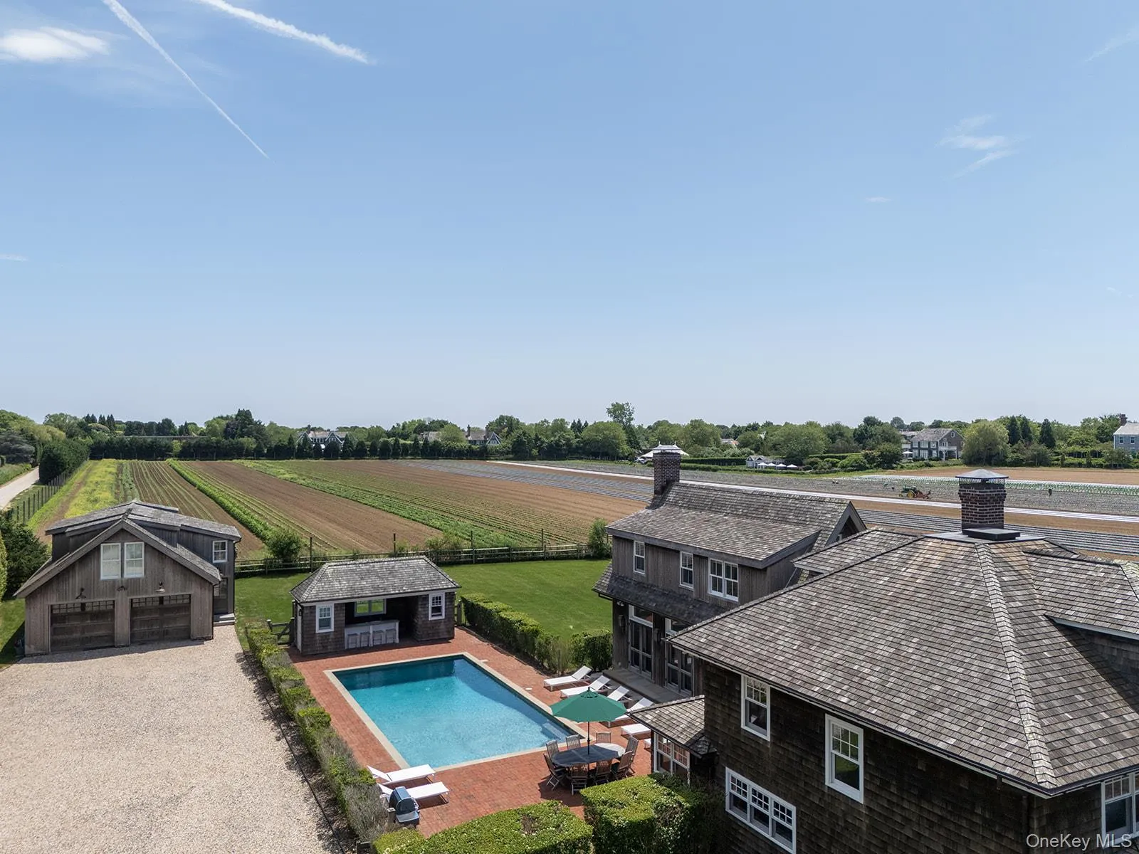 View of pool with an outdoor structure, a patio area, agricultural area, an exterior structure, and a rural view View of pool with an outdoor structure, a patio area, agricultural area, an exterior structure, and a rural view