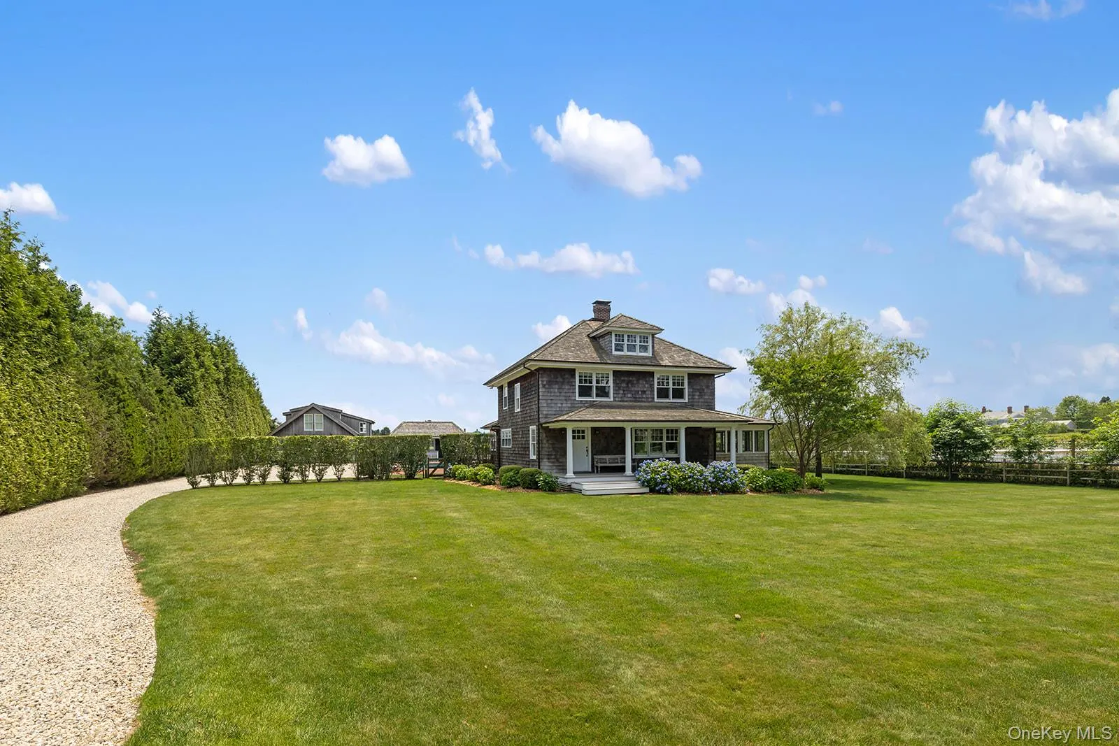 Back of house featuring a chimney and covered porch Back of house featuring a chimney and covered porch