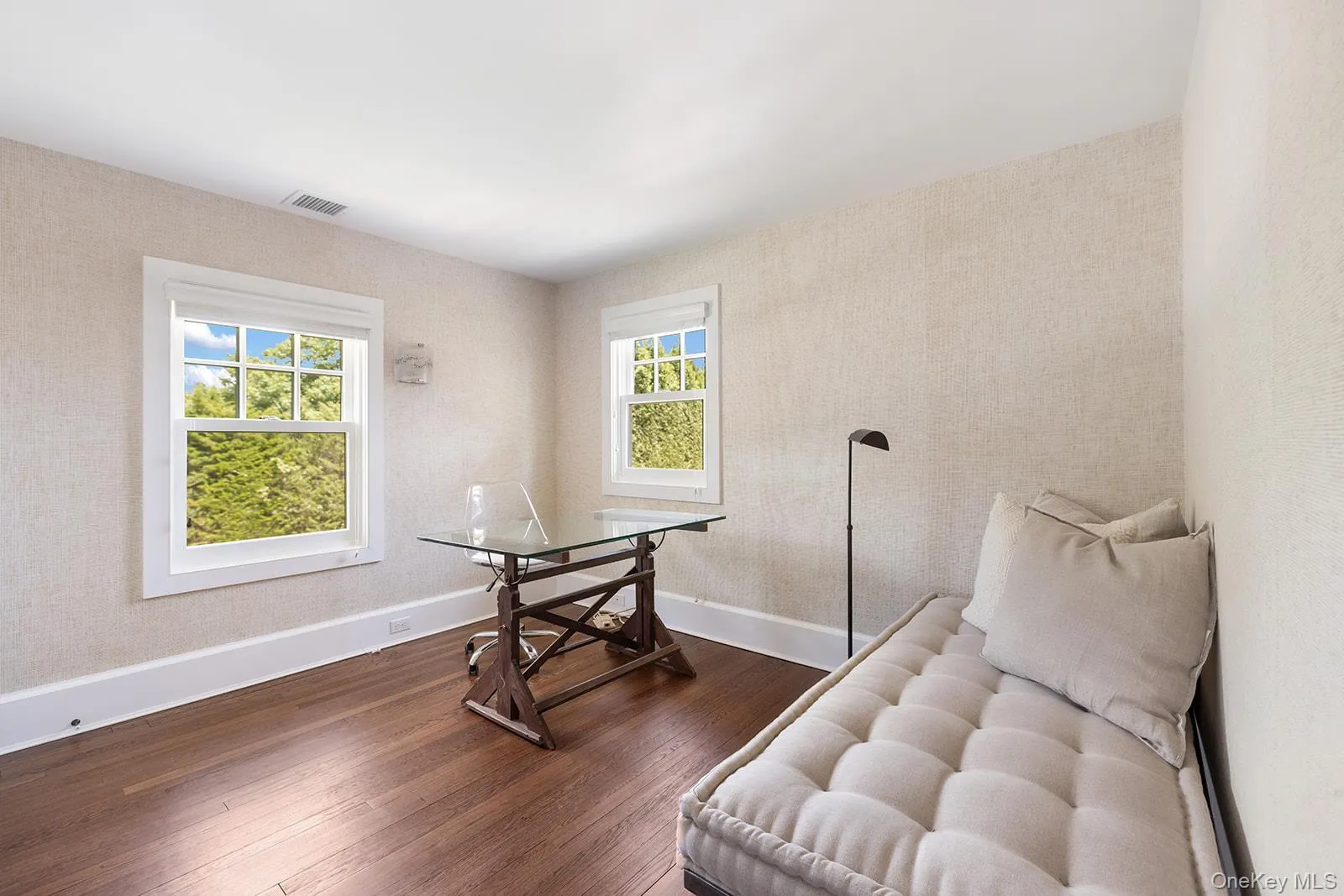 Office space with dark wood-style floors and healthy amount of natural light Office space with dark wood-style floors and healthy amount of natural light