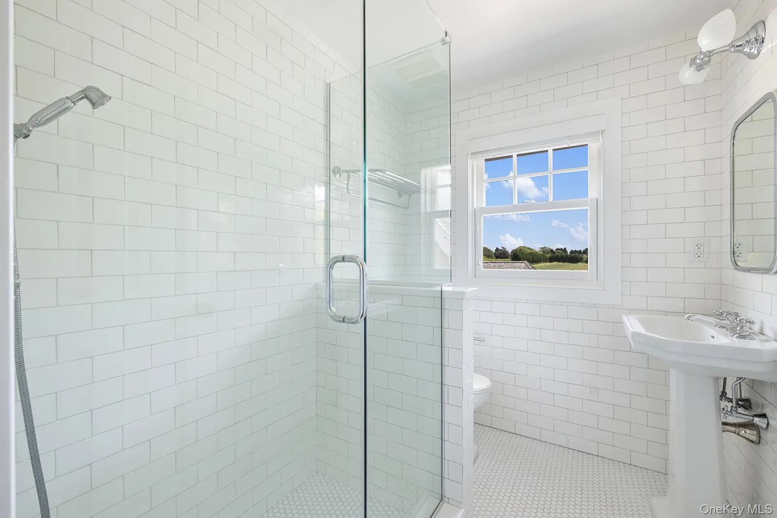 Bathroom featuring tile walls, a shower stall, and tile patterned flooring Bathroom featuring tile walls, a shower stall, and tile patterned flooring