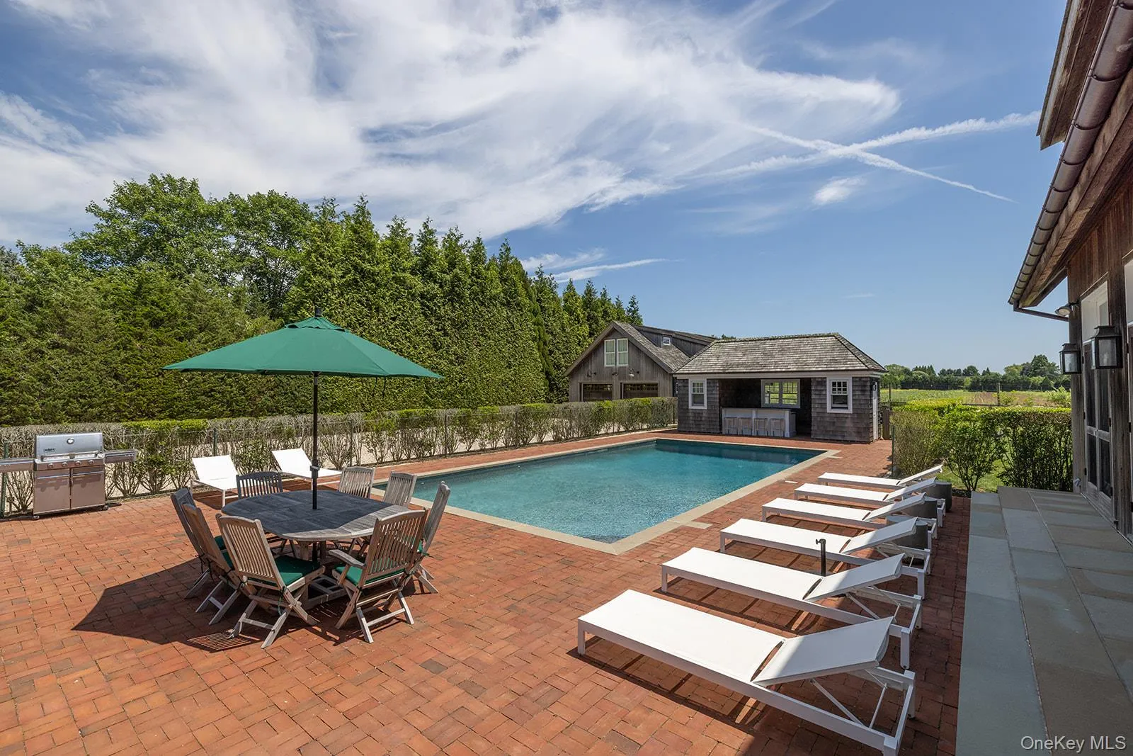View of swimming pool featuring a patio area, an outbuilding, a storage structure, grilling area, and outdoor dining space View of swimming pool featuring a patio area, an outbuilding, a storage structure, grilling area, and outdoor dining space