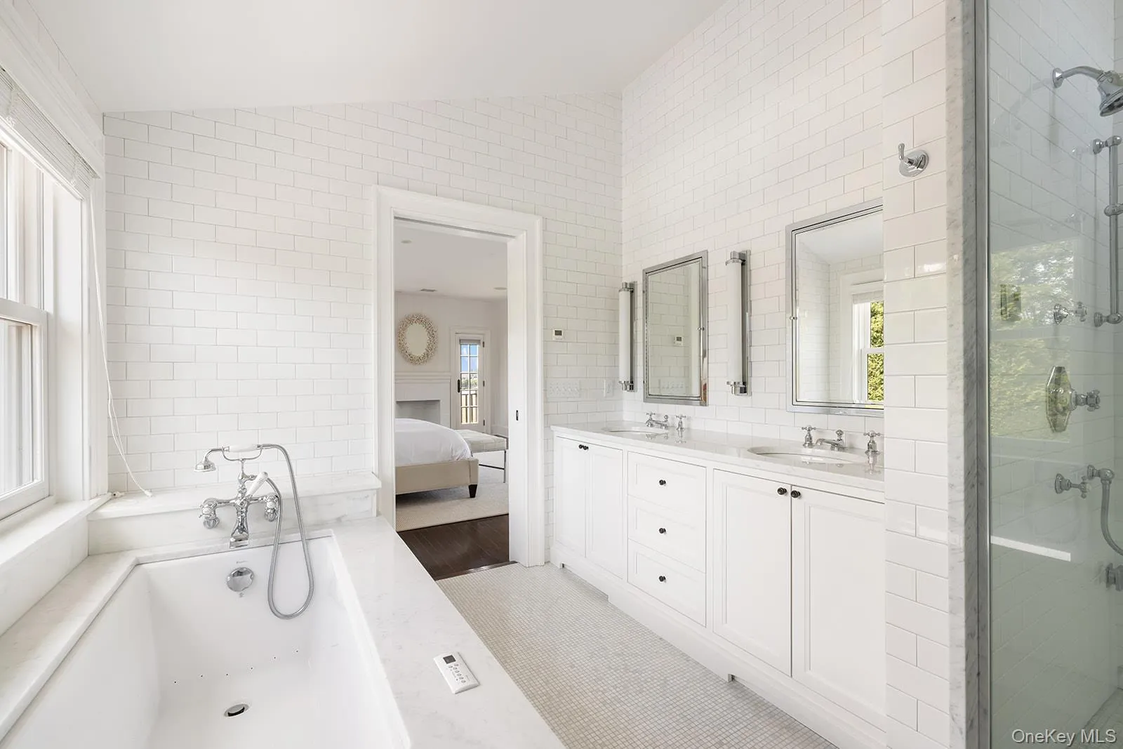 Ensuite bathroom with lofted ceiling, double vanity, a bath, and a stall shower Ensuite bathroom with lofted ceiling, double vanity, a bath, and a stall shower