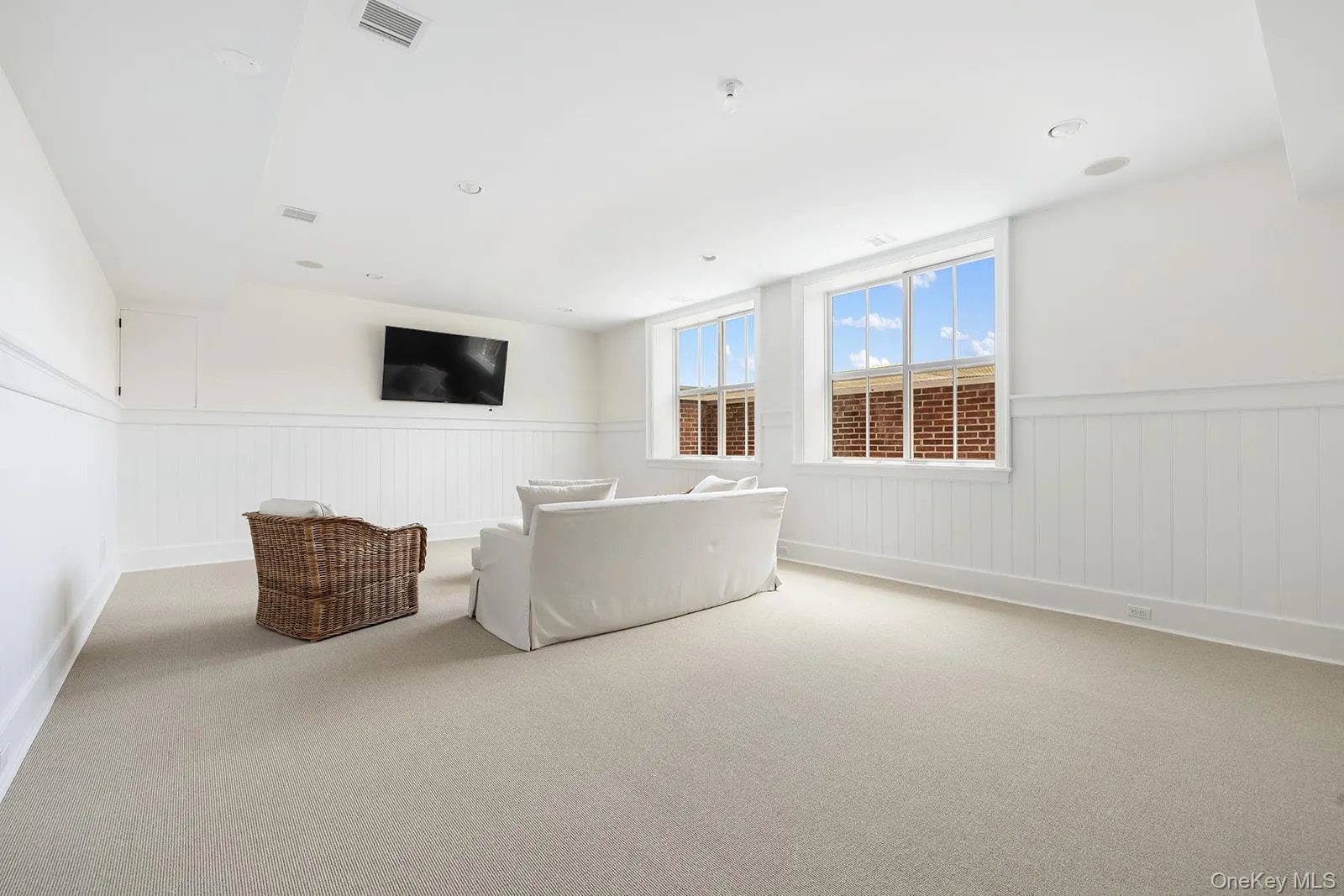 Living room with carpet floors, wainscoting, and recessed lighting Living room with carpet floors, wainscoting, and recessed lighting