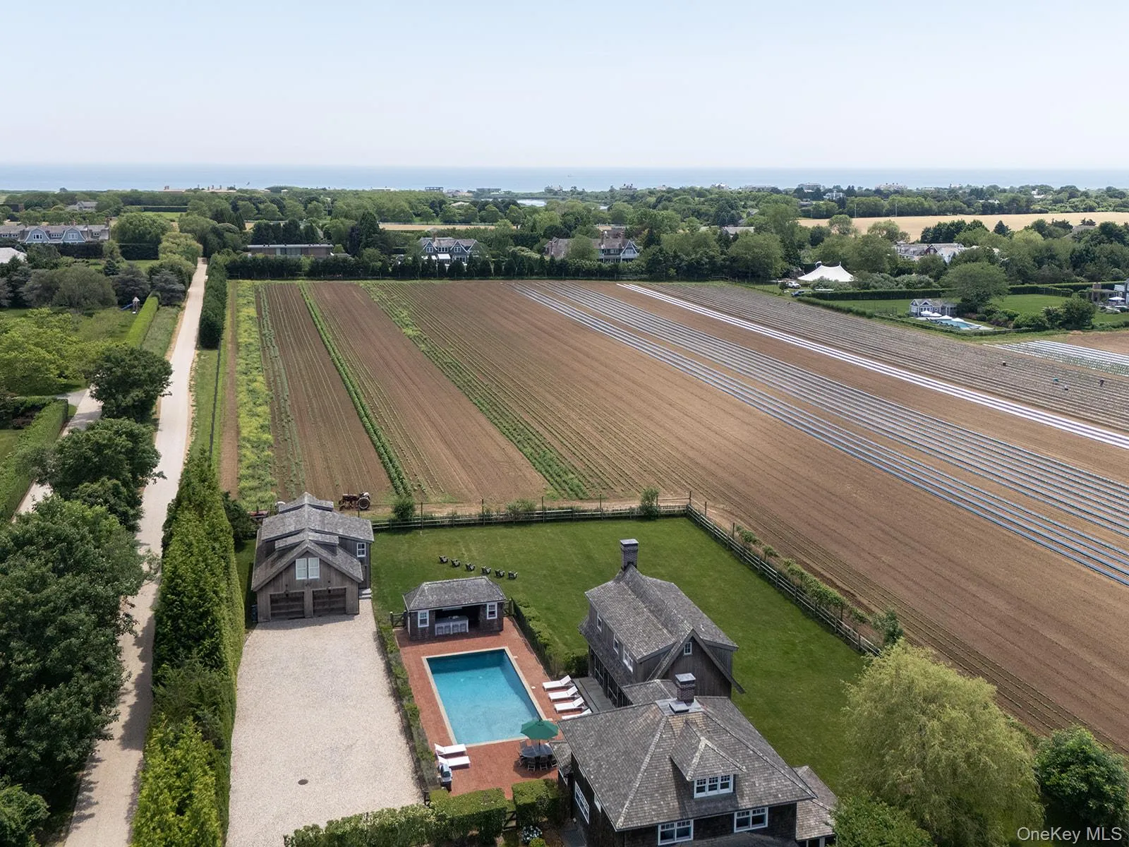 Aerial view of sparsely populated area featuring a nearby body of water and extensive farmland Aerial view of sparsely populated area featuring a nearby body of water and extensive farmland