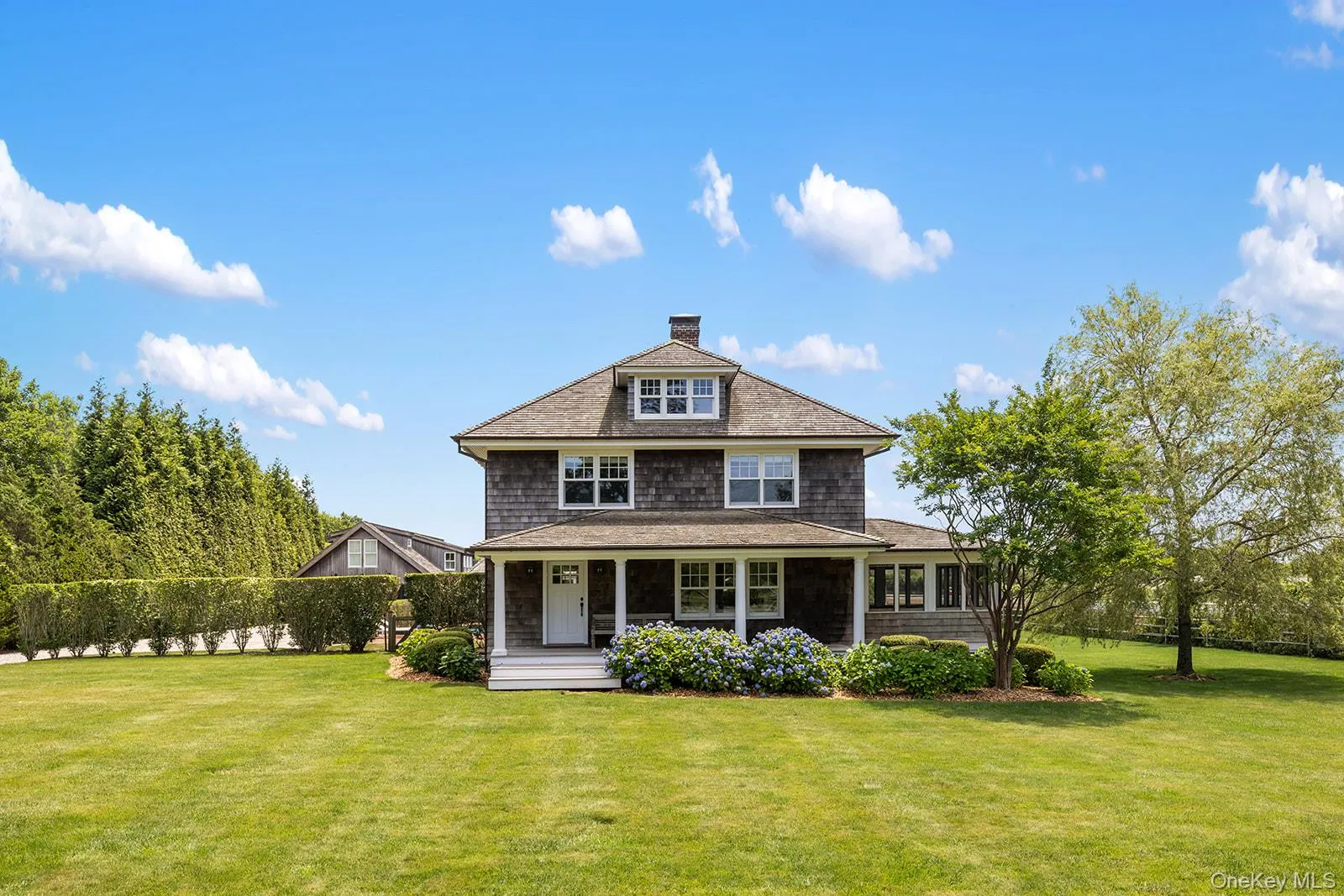 View of front of house with a chimney, a porch, and a shingled roof View of front of house with a chimney, a porch, and a shingled roof