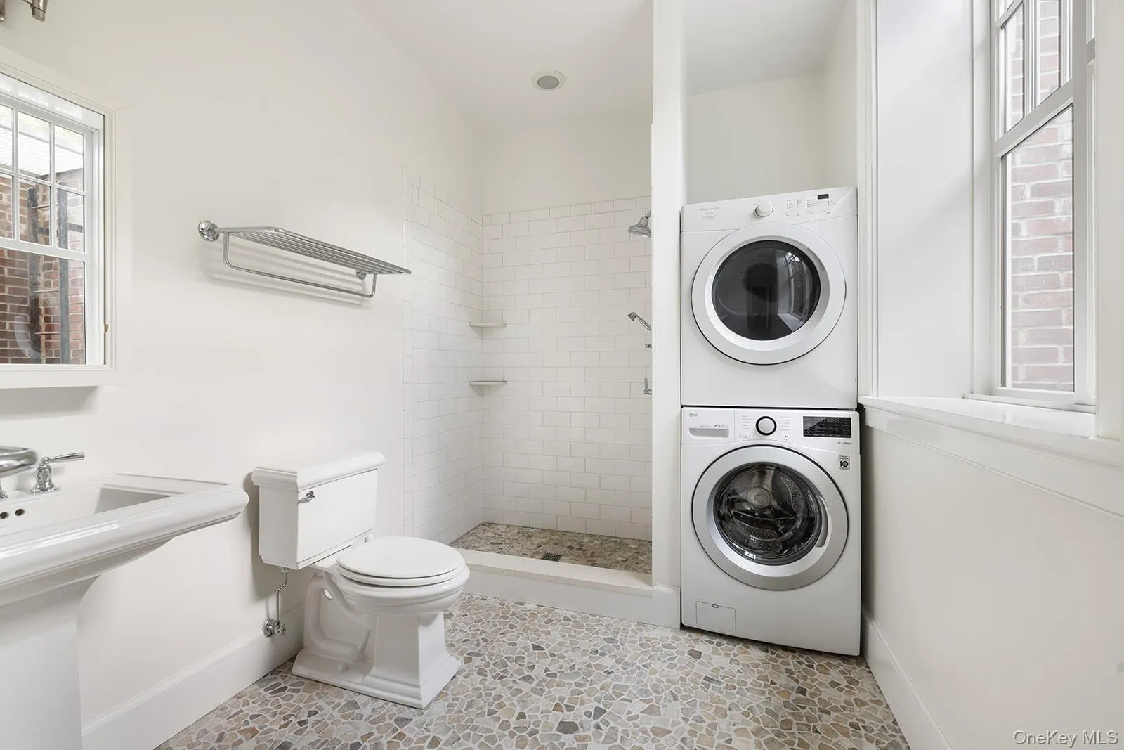 Bathroom with a shower stall and estacked washer and dryer Bathroom with a shower stall and estacked washer and dryer