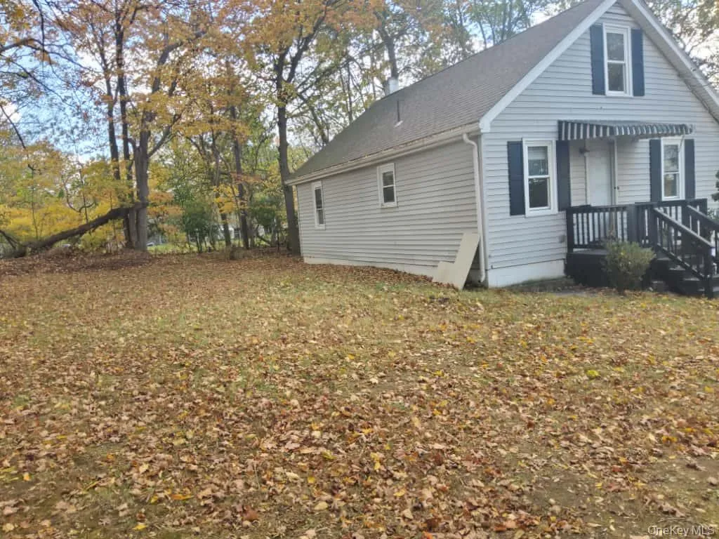 View of side of property featuring a yard View of side of property featuring a yard