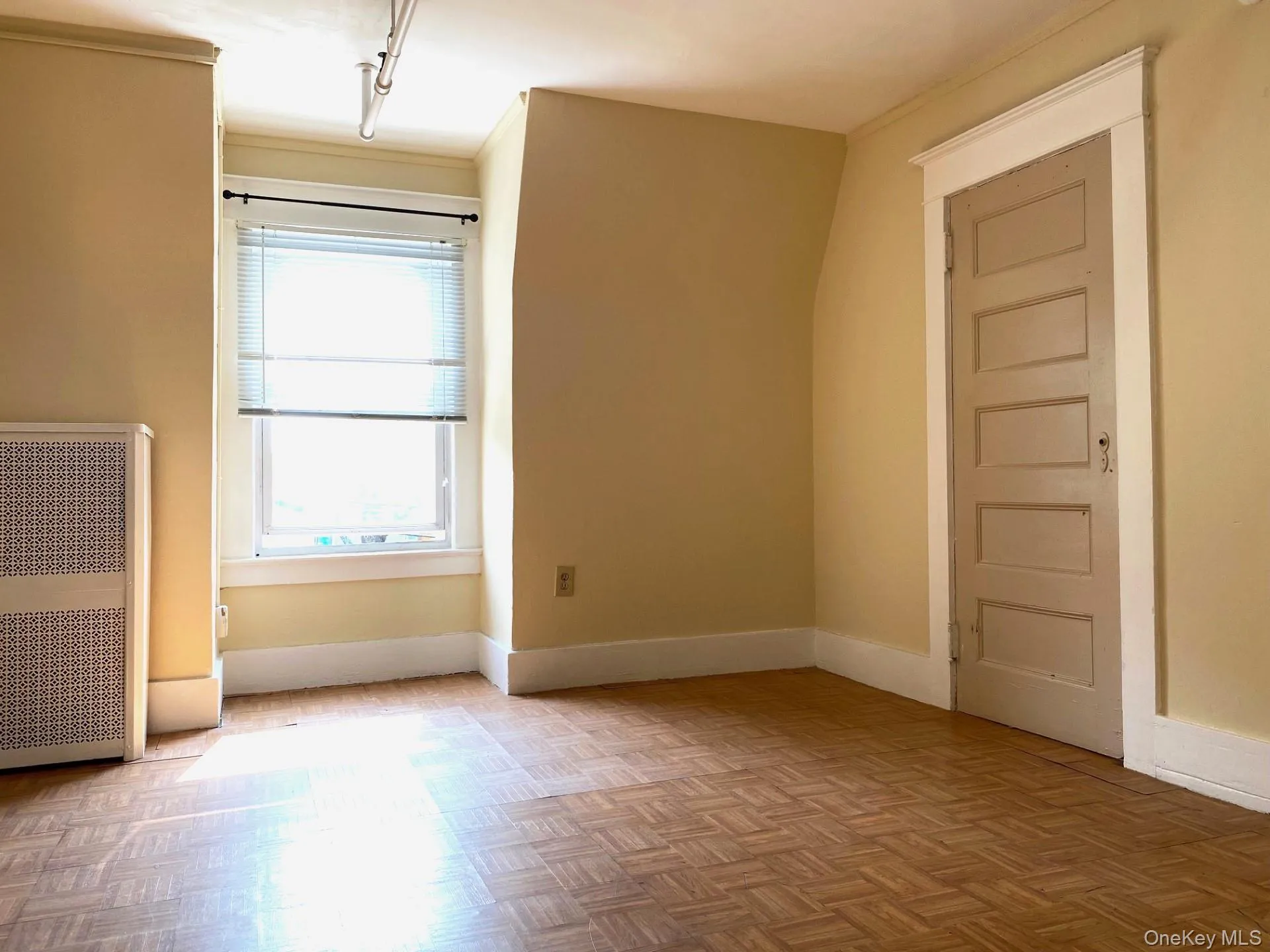 Empty room featuring radiator and baseboards Empty room featuring radiator and baseboards