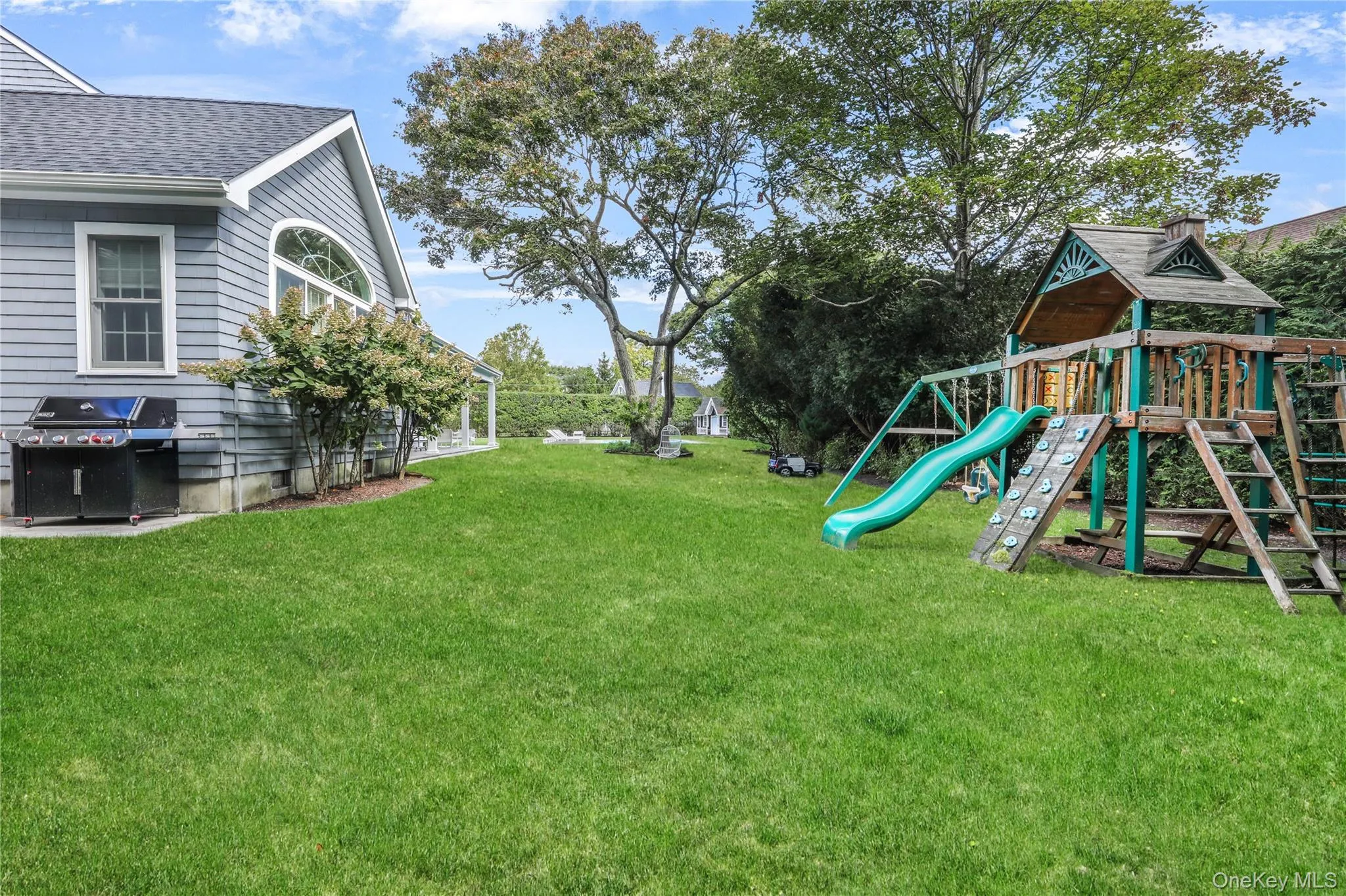 View of grassy yard with a playground View of grassy yard with a playground