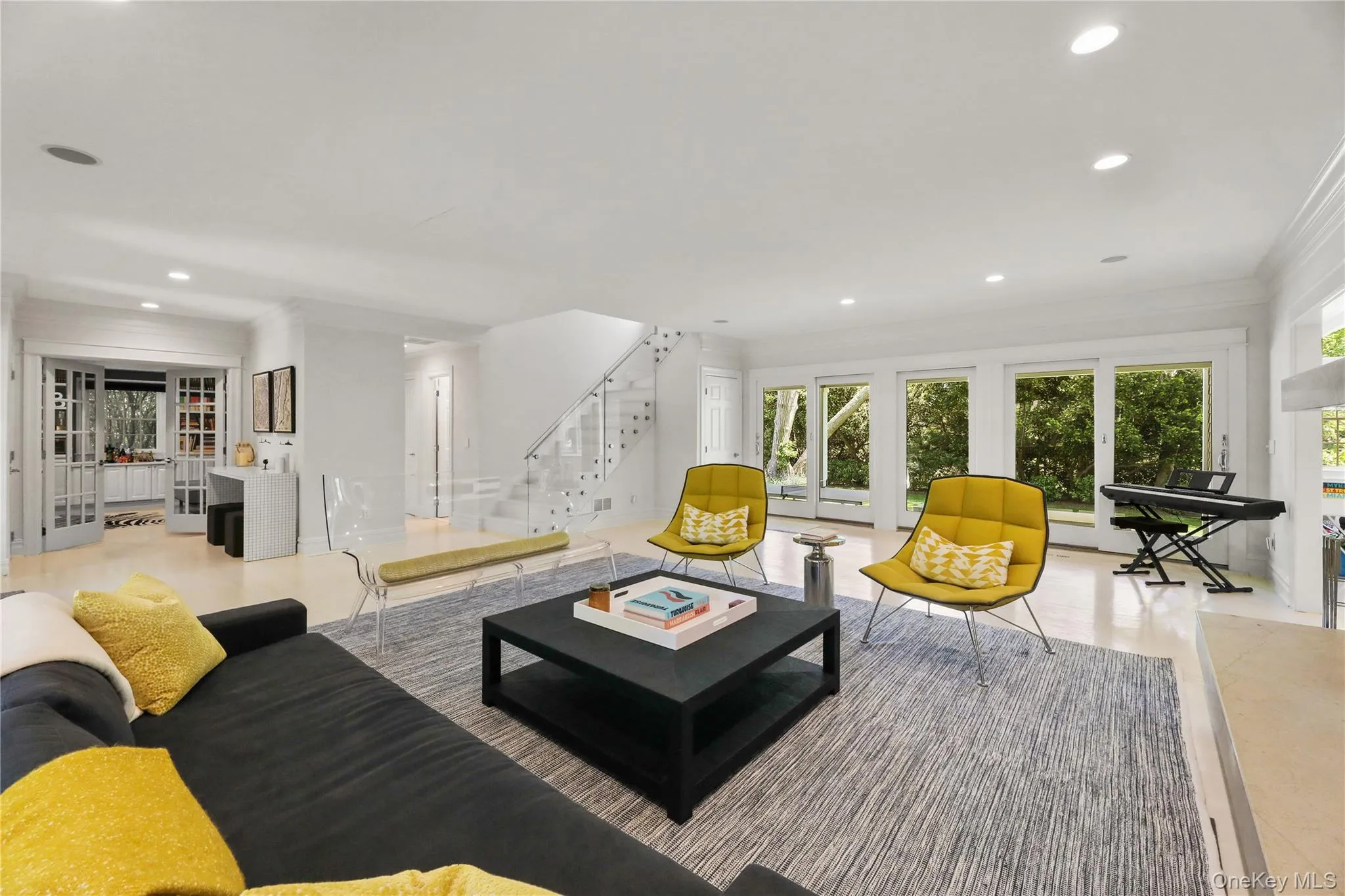 Living area with recessed lighting, plenty of natural light, stairway, and crown molding Living area with recessed lighting, plenty of natural light, stairway, and crown molding