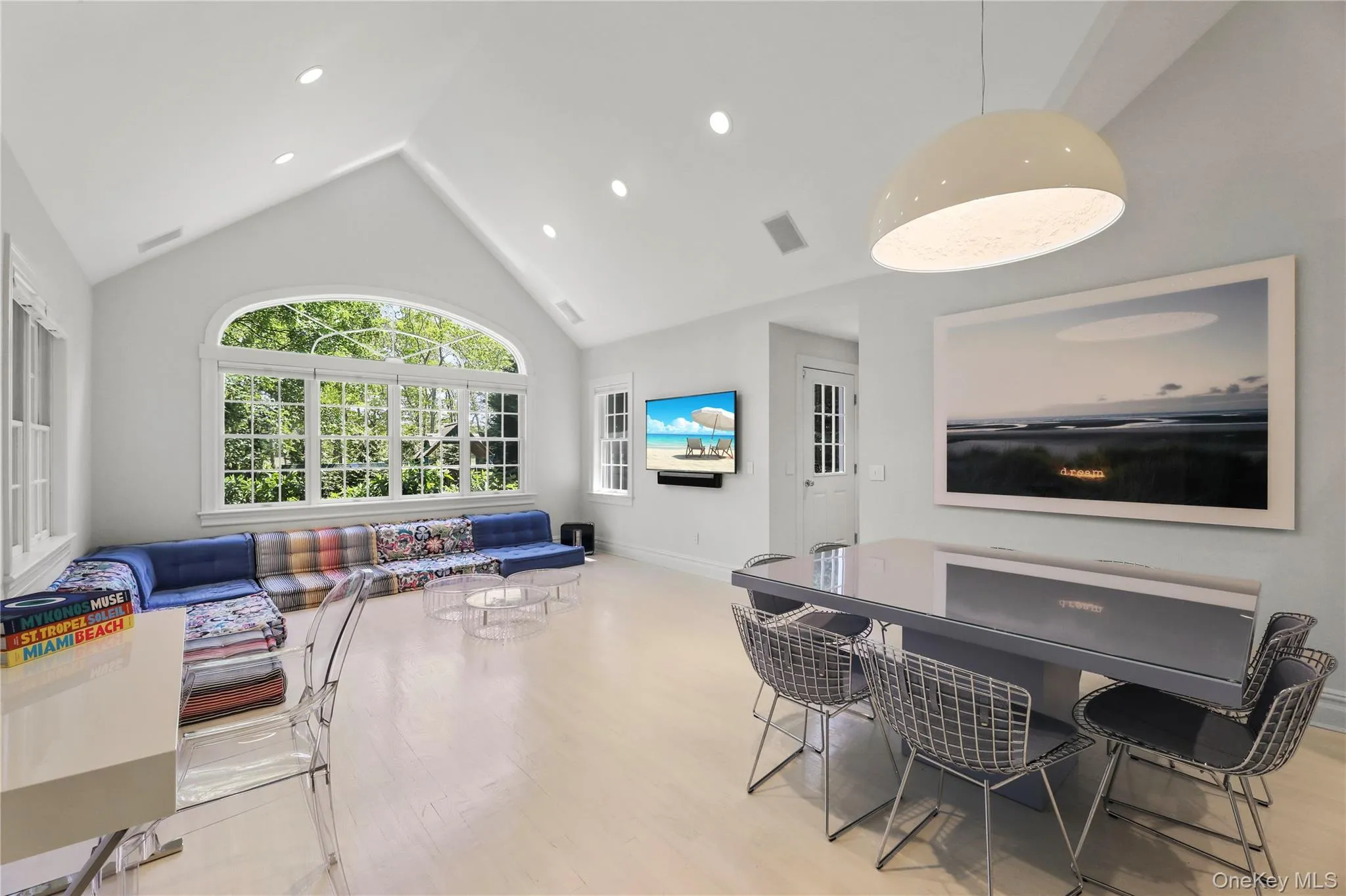 Dining area featuring high vaulted ceiling, visible vents, recessed lighting, wood finished floors, and baseboards Dining area featuring high vaulted ceiling, visible vents, recessed lighting, wood finished floors, and baseboards