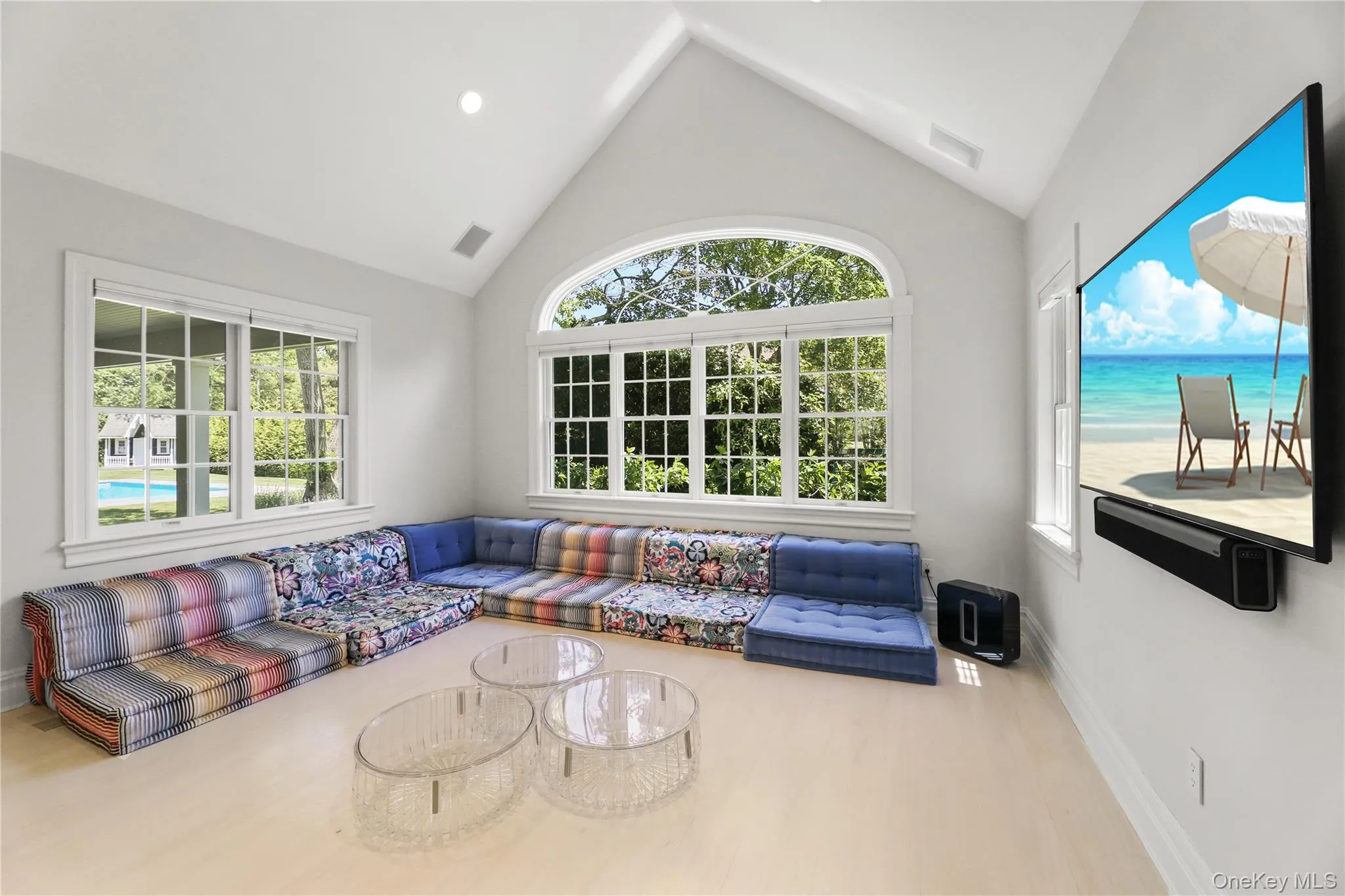 Living area featuring wood finished floors, baseboards, and visible vents Living area featuring wood finished floors, baseboards, and visible vents