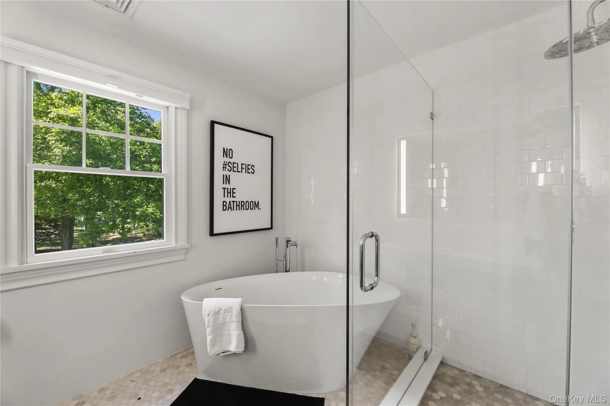 Full bathroom featuring a freestanding tub and a stall shower Full bathroom featuring a freestanding tub and a stall shower