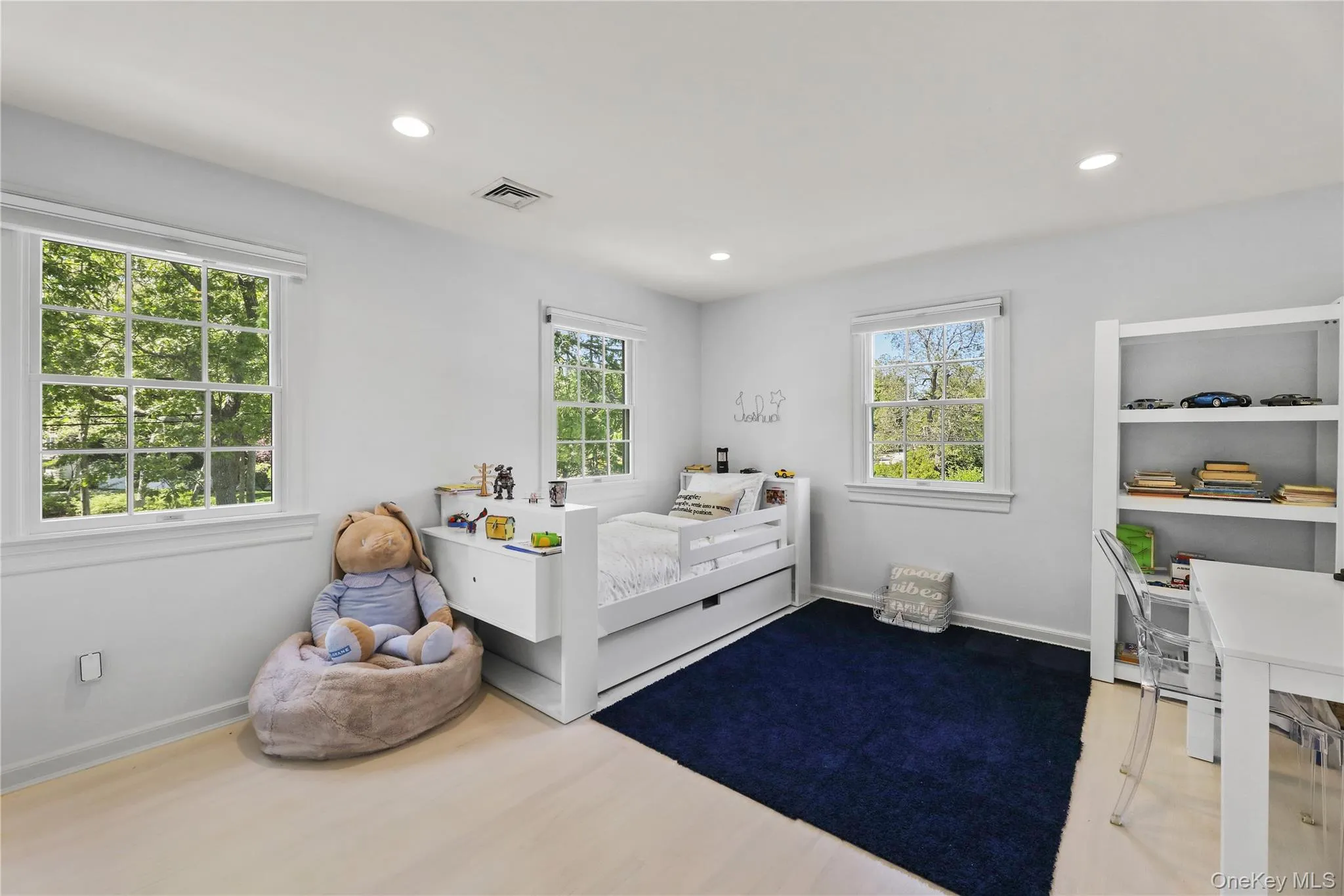 Bedroom with visible vents, recessed lighting, multiple windows, and wood finished floors Bedroom with visible vents, recessed lighting, multiple windows, and wood finished floors