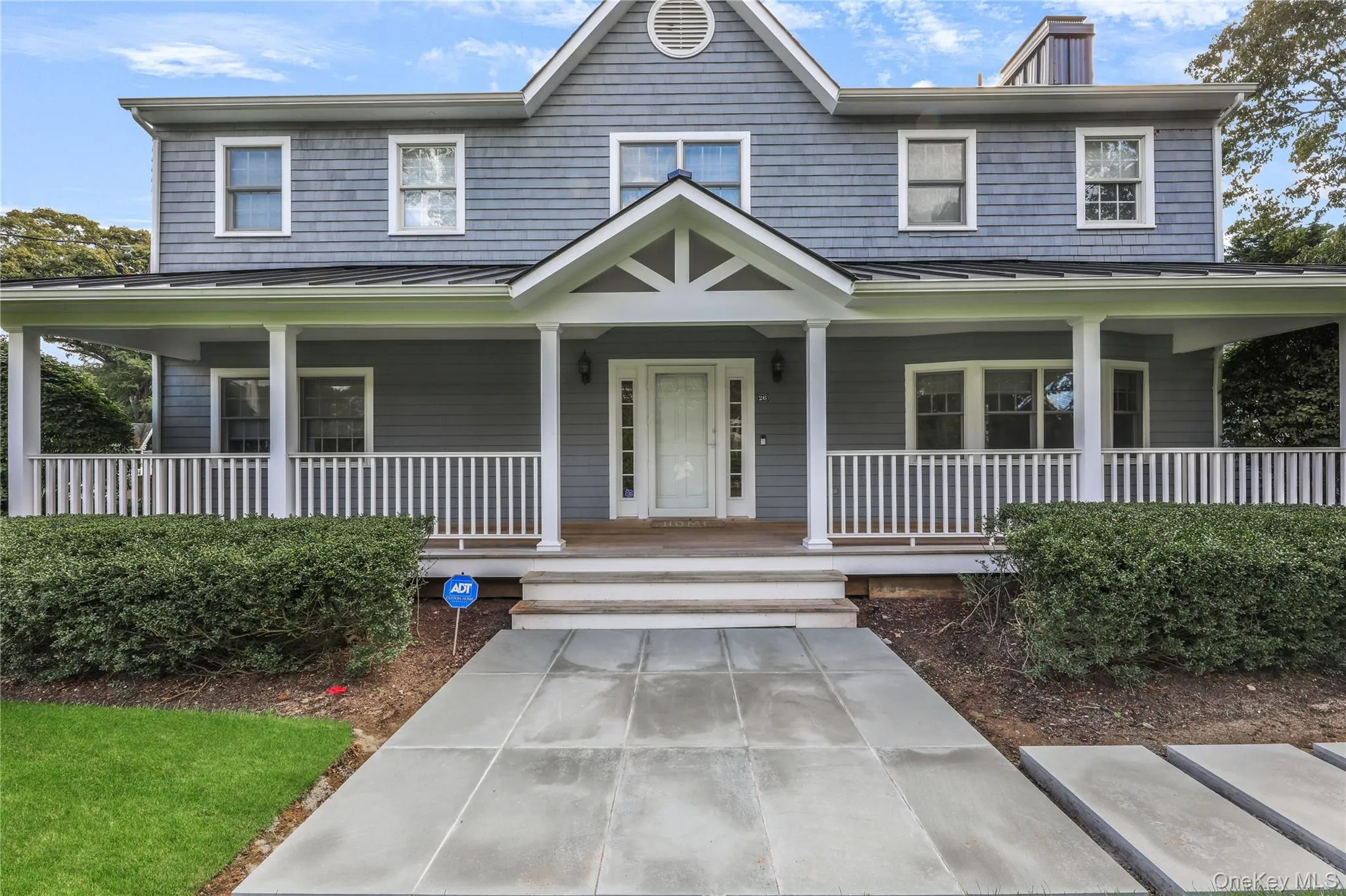 View of front of home featuring a standing seam roof, a metal roof, covered porch, and a chimney View of front of home featuring a standing seam roof, a metal roof, covered porch, and a chimney