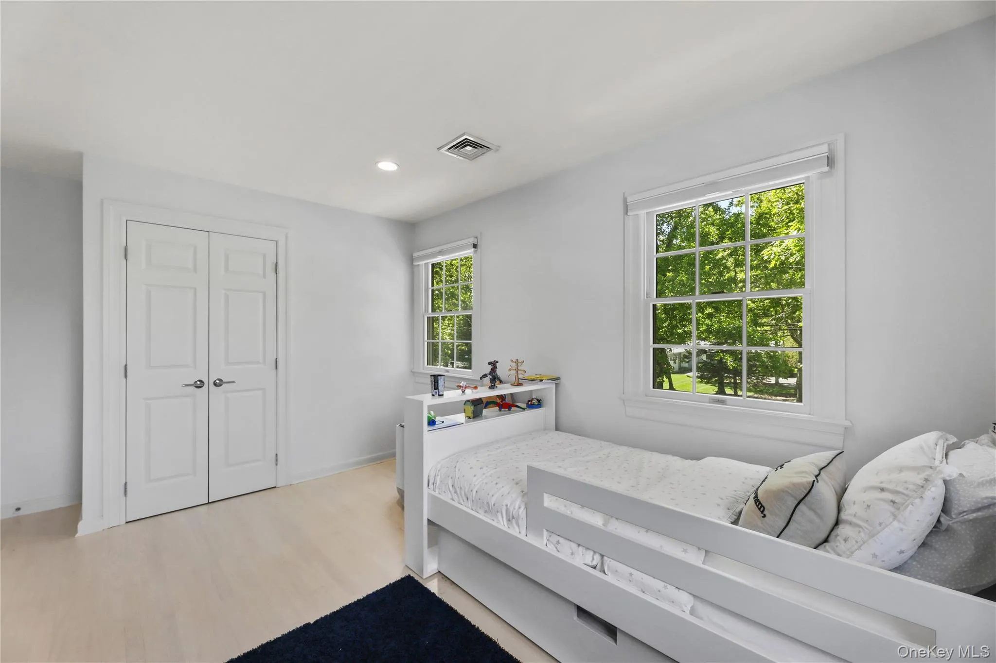Bedroom featuring visible vents, recessed lighting, a closet, and light wood-style floors Bedroom featuring visible vents, recessed lighting, a closet, and light wood-style floors