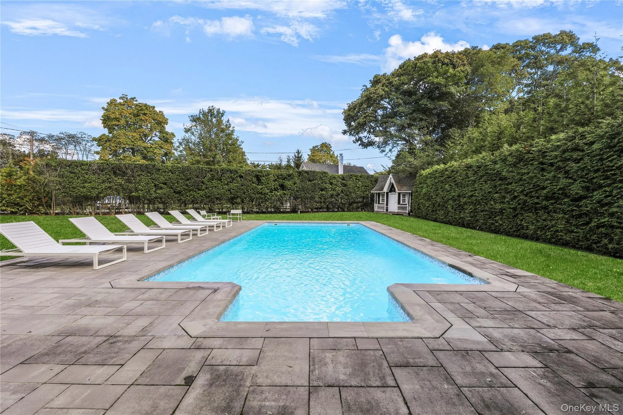 View of pool with a patio and an outdoor structure View of pool with a patio and an outdoor structure