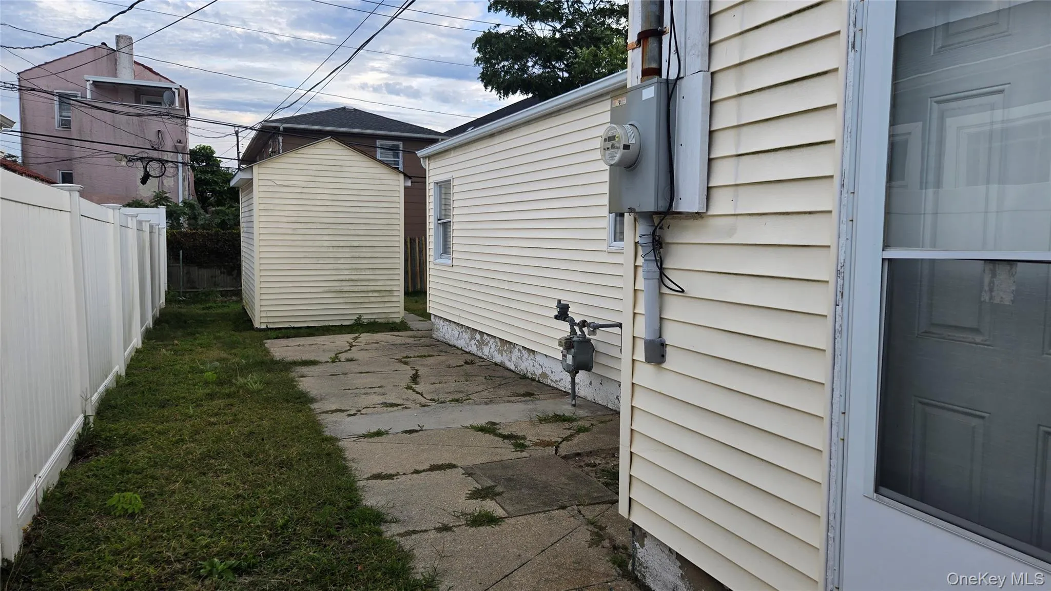 View of side of property with a patio and a shed View of side of property with a patio and a shed