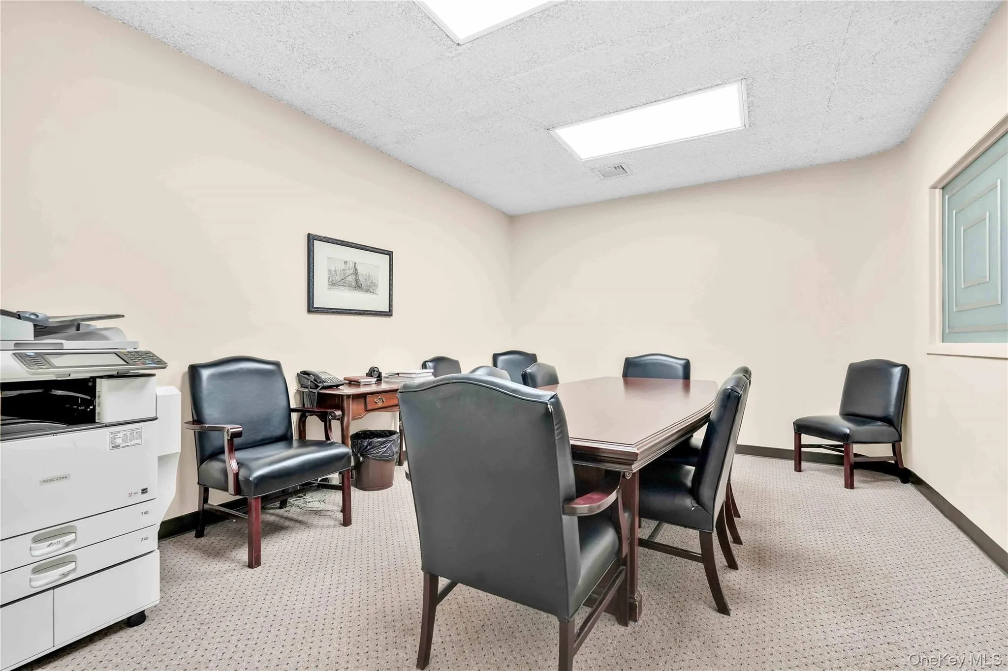 Home office featuring light colored carpet and a textured ceiling Home office featuring light colored carpet and a textured ceiling