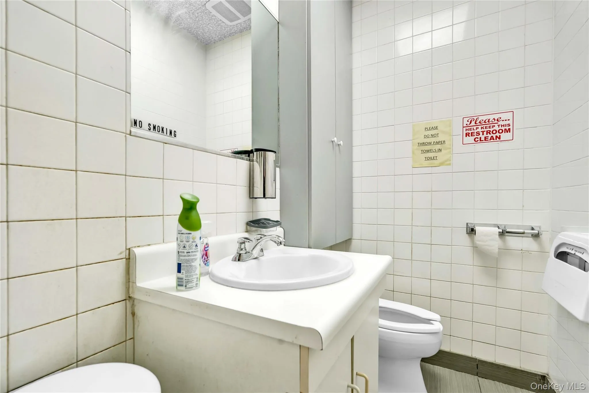 Bathroom featuring tile walls and vanity Bathroom featuring tile walls and vanity