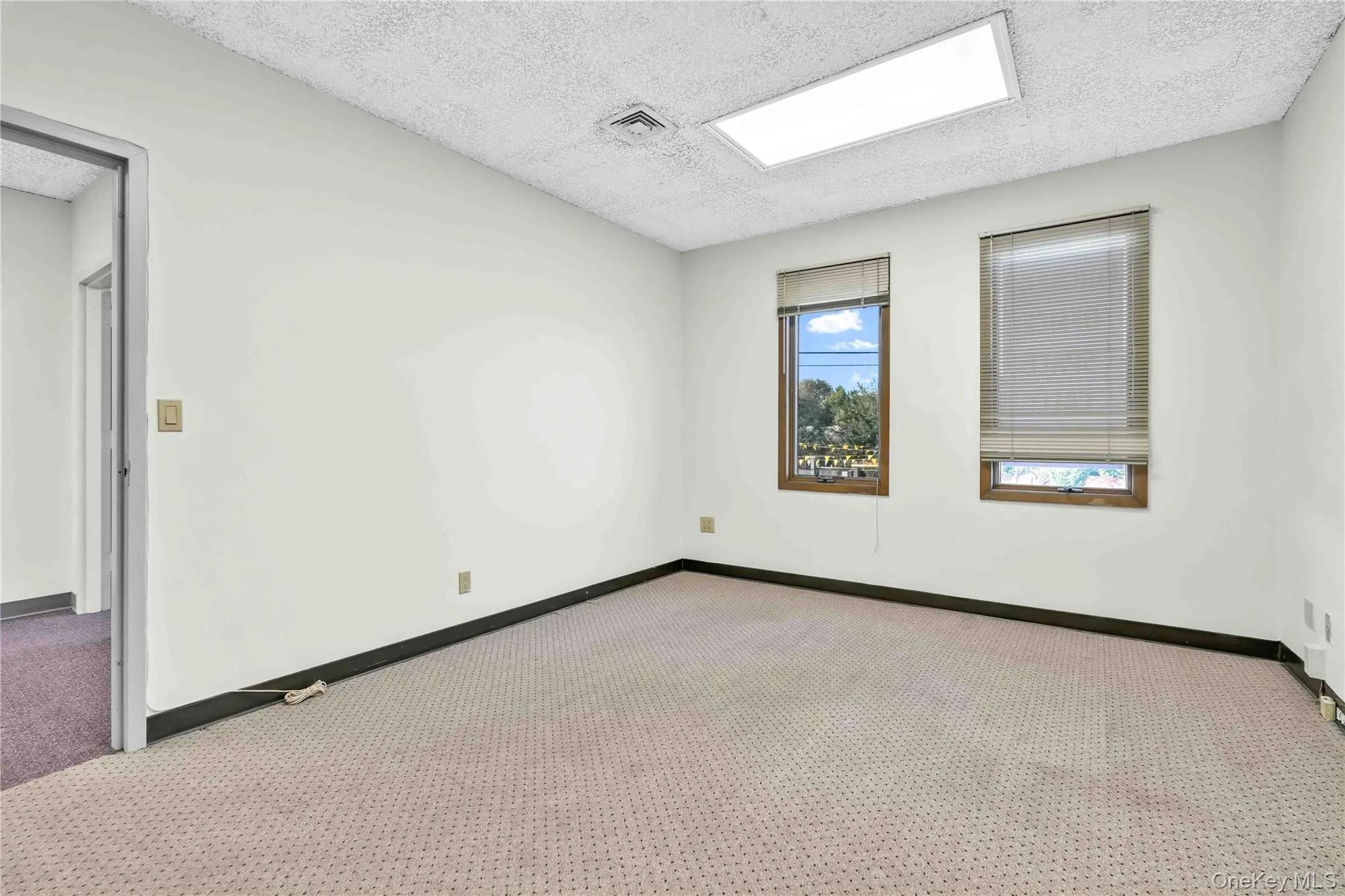 Empty room featuring a textured ceiling and carpet floors Empty room featuring a textured ceiling and carpet floors