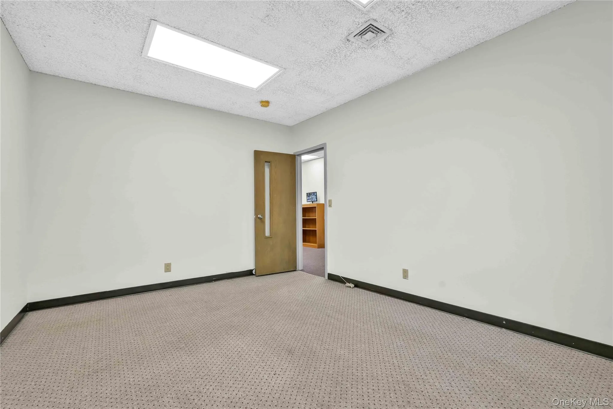 Carpeted empty room with a textured ceiling Carpeted empty room with a textured ceiling