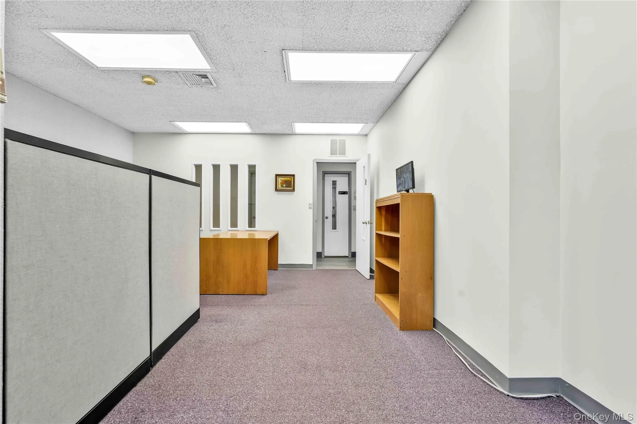 Corridor featuring light colored carpet and baseboards Corridor featuring light colored carpet and baseboards