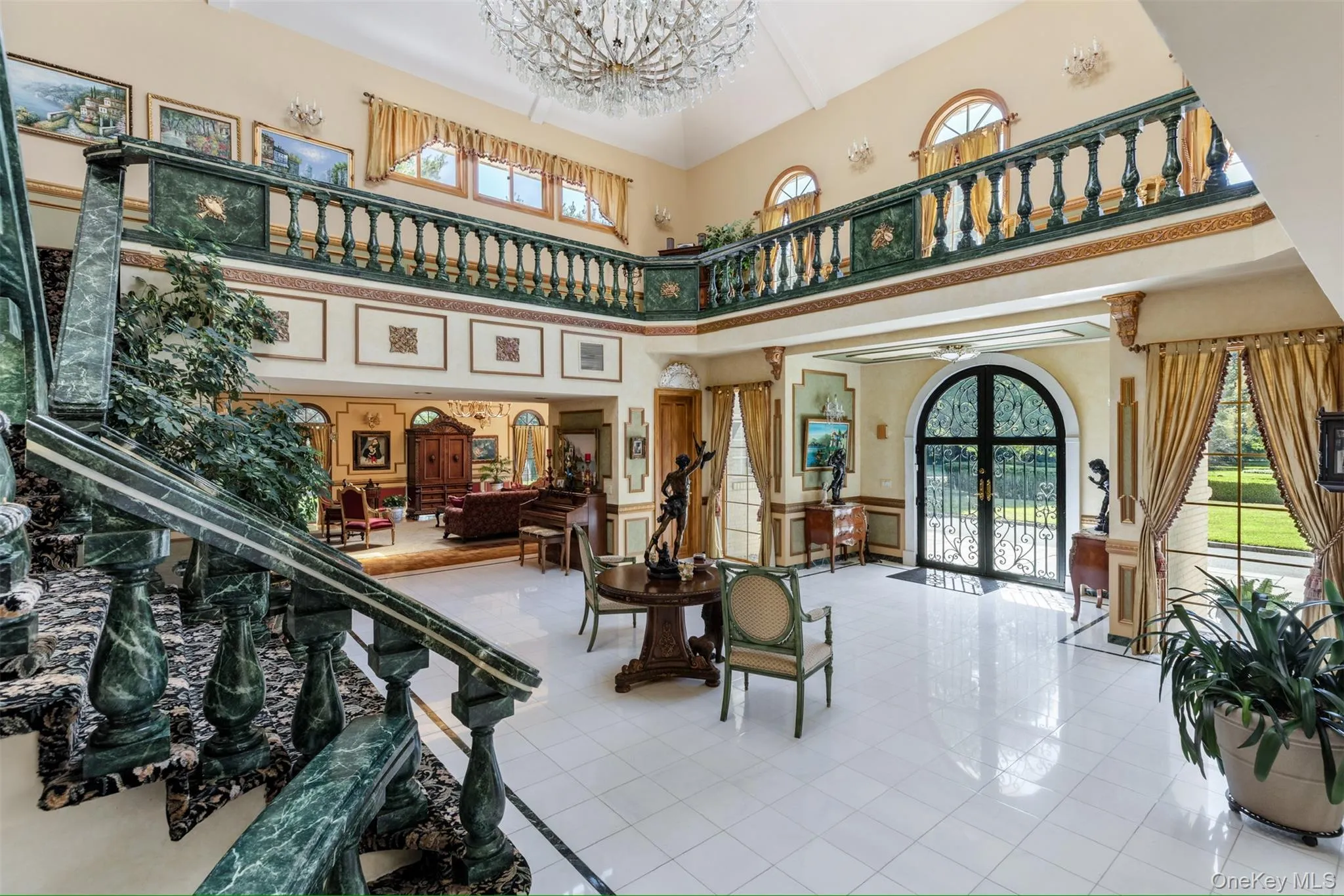 Common area with a towering ceiling, stairs, and wainscoting Common area with a towering ceiling, stairs, and wainscoting