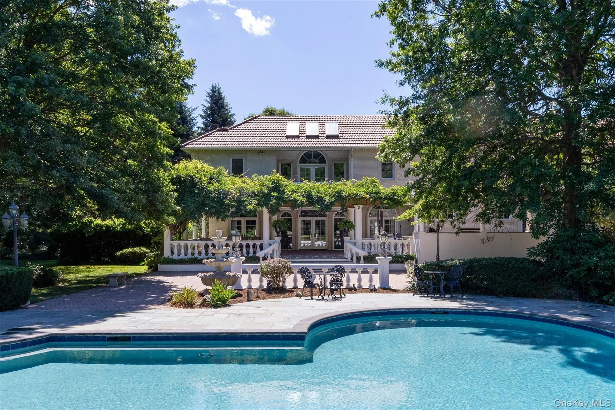 Outdoor pool with a patio area and french doors Outdoor pool with a patio area and french doors