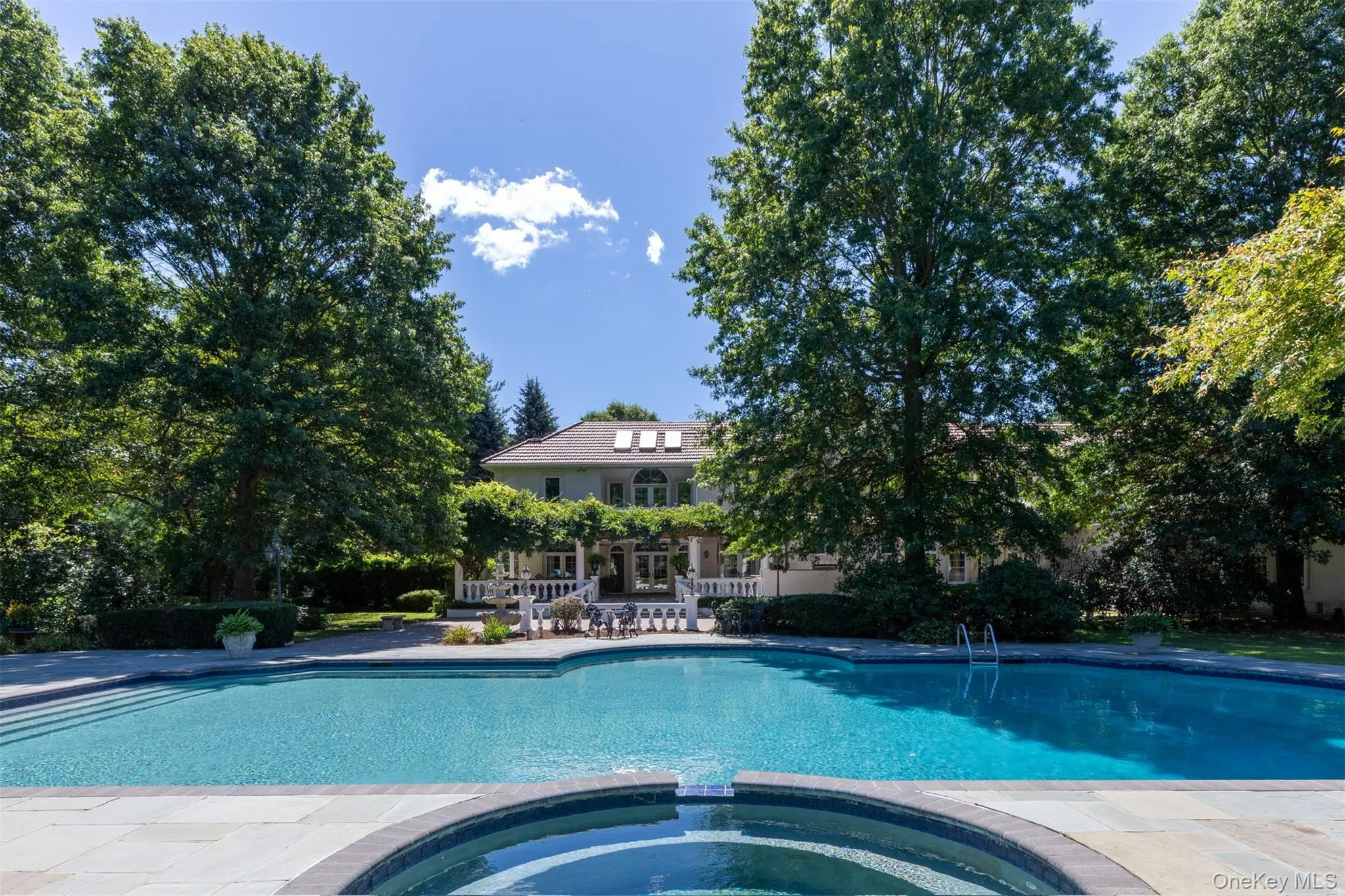 View of pool with a pool with connected hot tub and a patio area View of pool with a pool with connected hot tub and a patio area