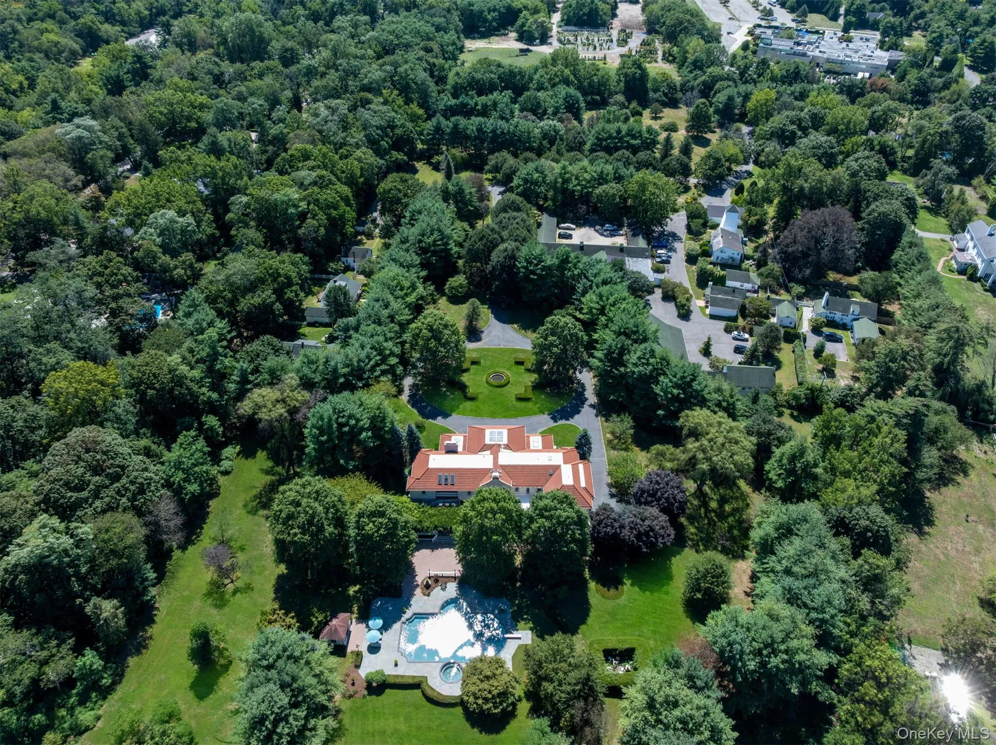 View of property location featuring a pool and a heavily wooded area View of property location featuring a pool and a heavily wooded area