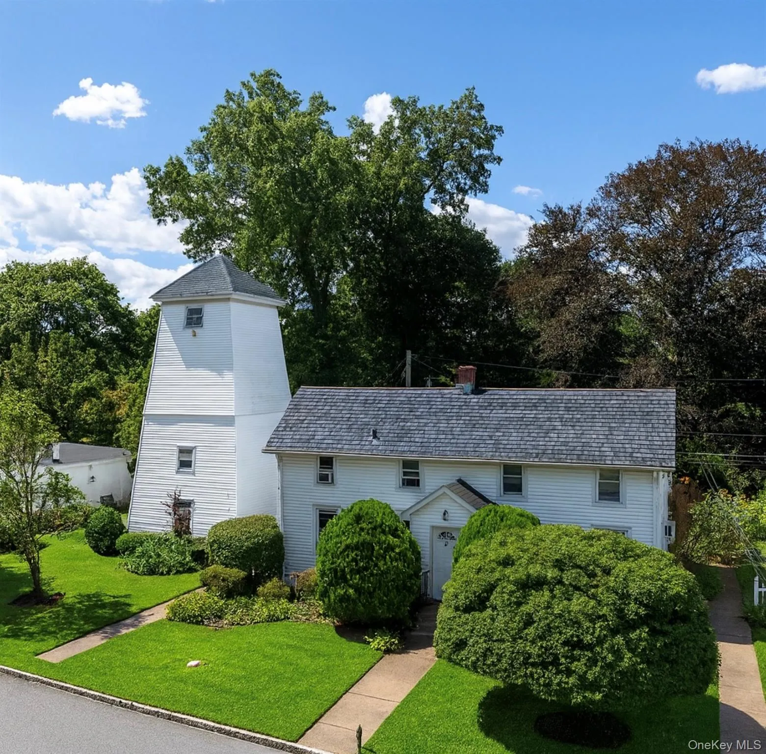 View of front of house featuring a front yard and a chimney View of front of house featuring a front yard and a chimney