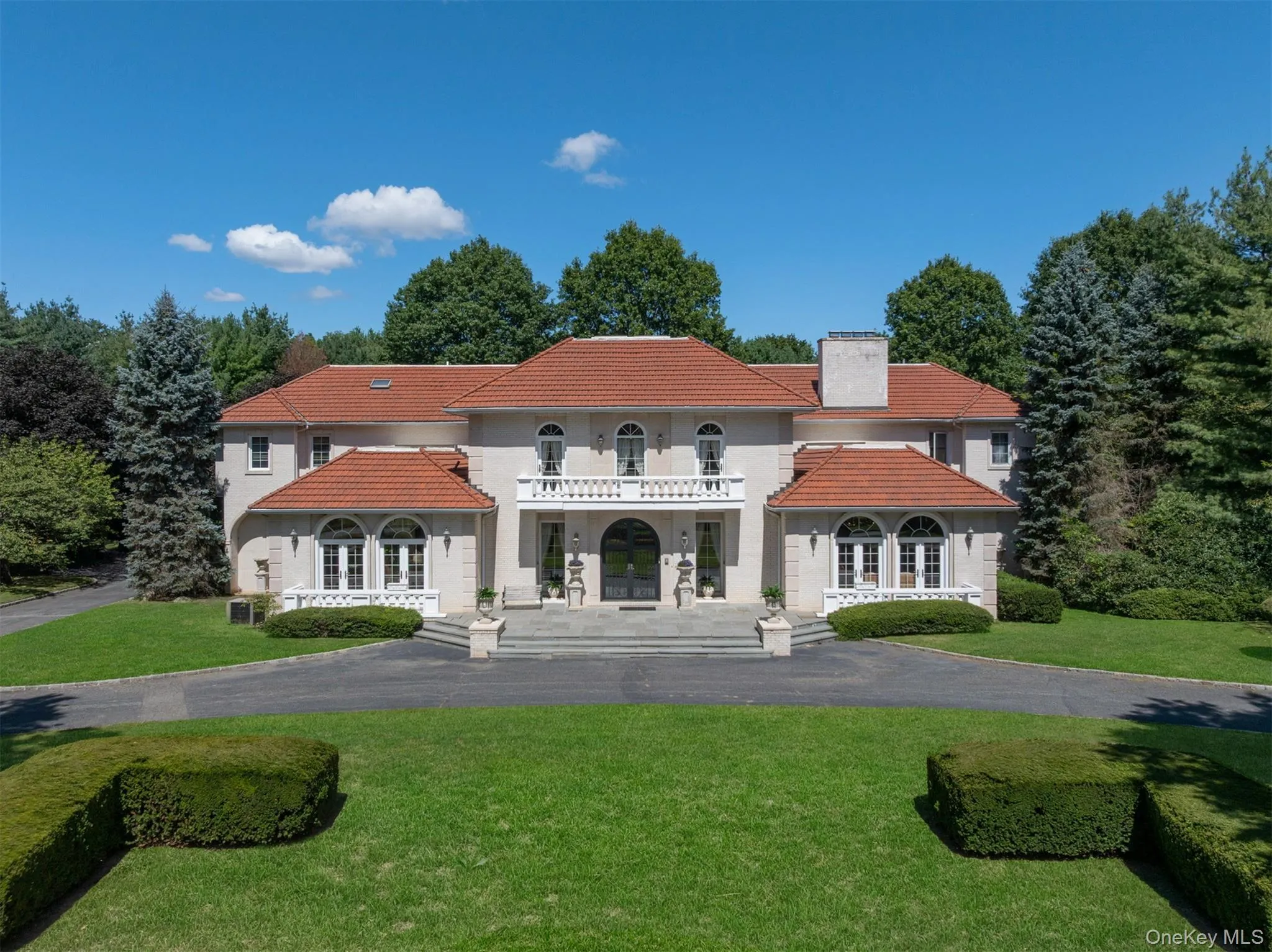 Back of property with a balcony, a yard, a tile roof, and a chimney Back of property with a balcony, a yard, a tile roof, and a chimney